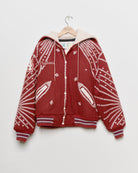 Red upcycled jacket with pearly buttons, front view. 