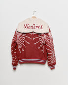 Red upcycled jacket with pearly buttons,
back view.