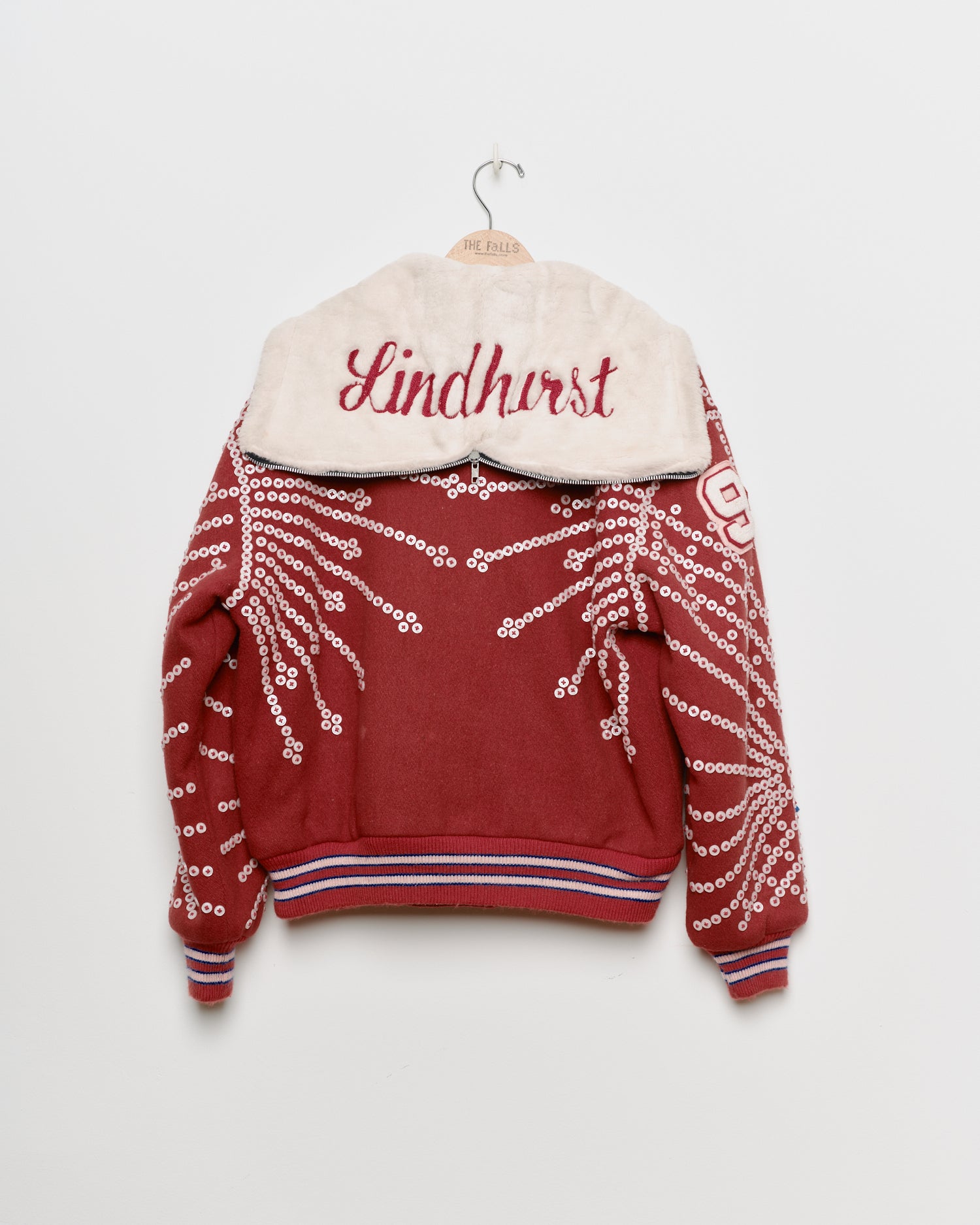 Red upcycled jacket with pearly buttons,
back view.