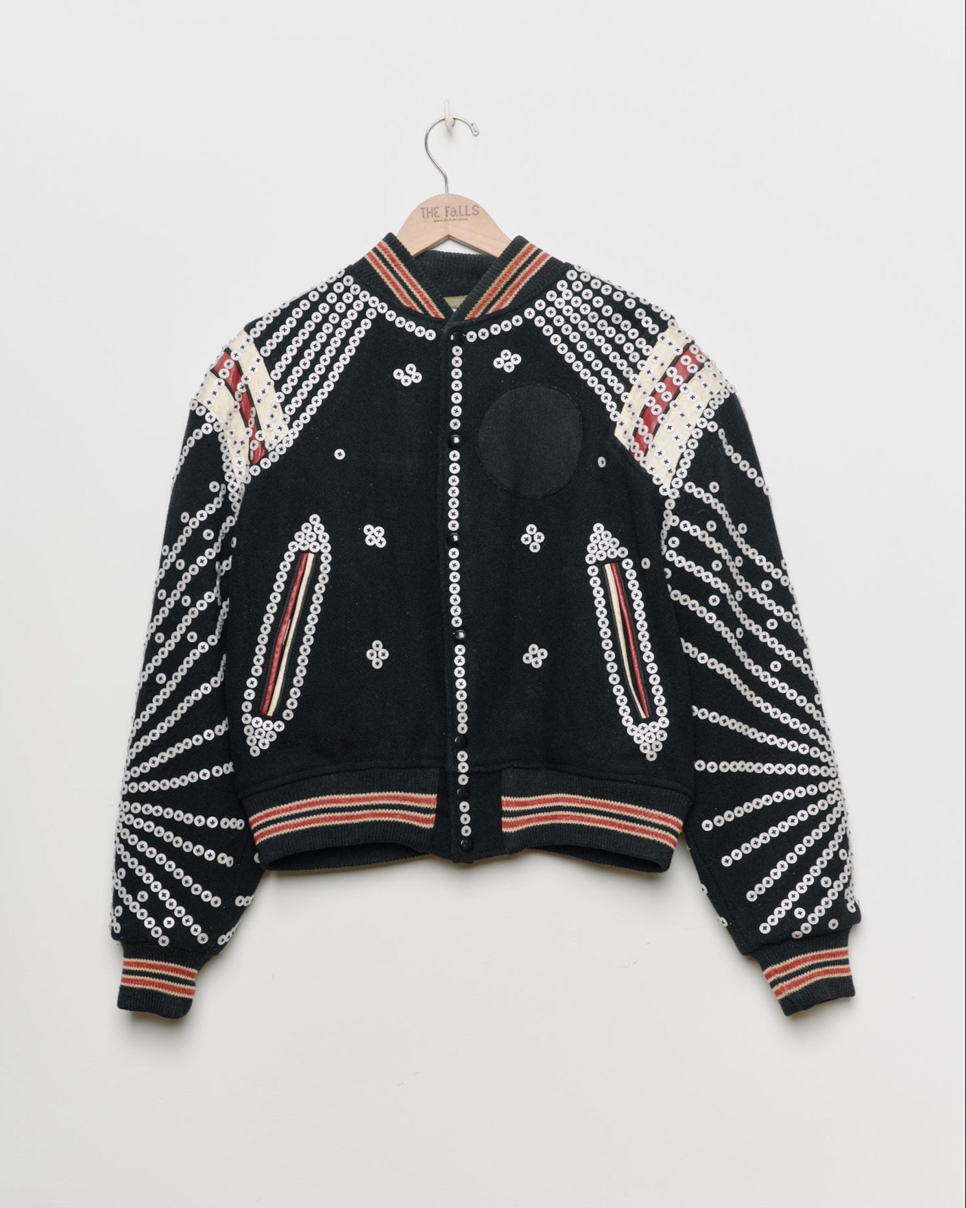 Black upcycled jacket with pearly buttons,
front view.