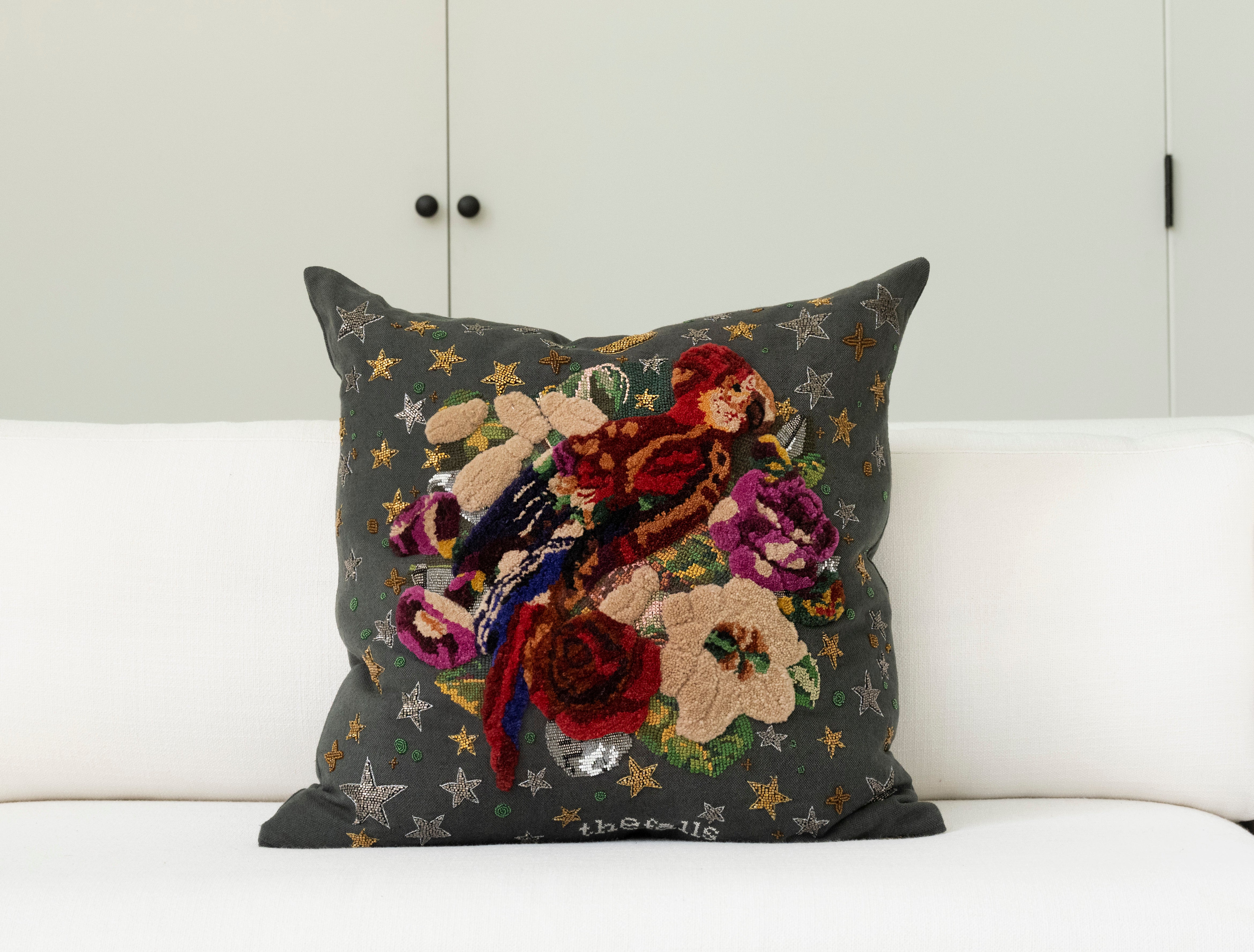 Pillow with tufted embellishments, font view 