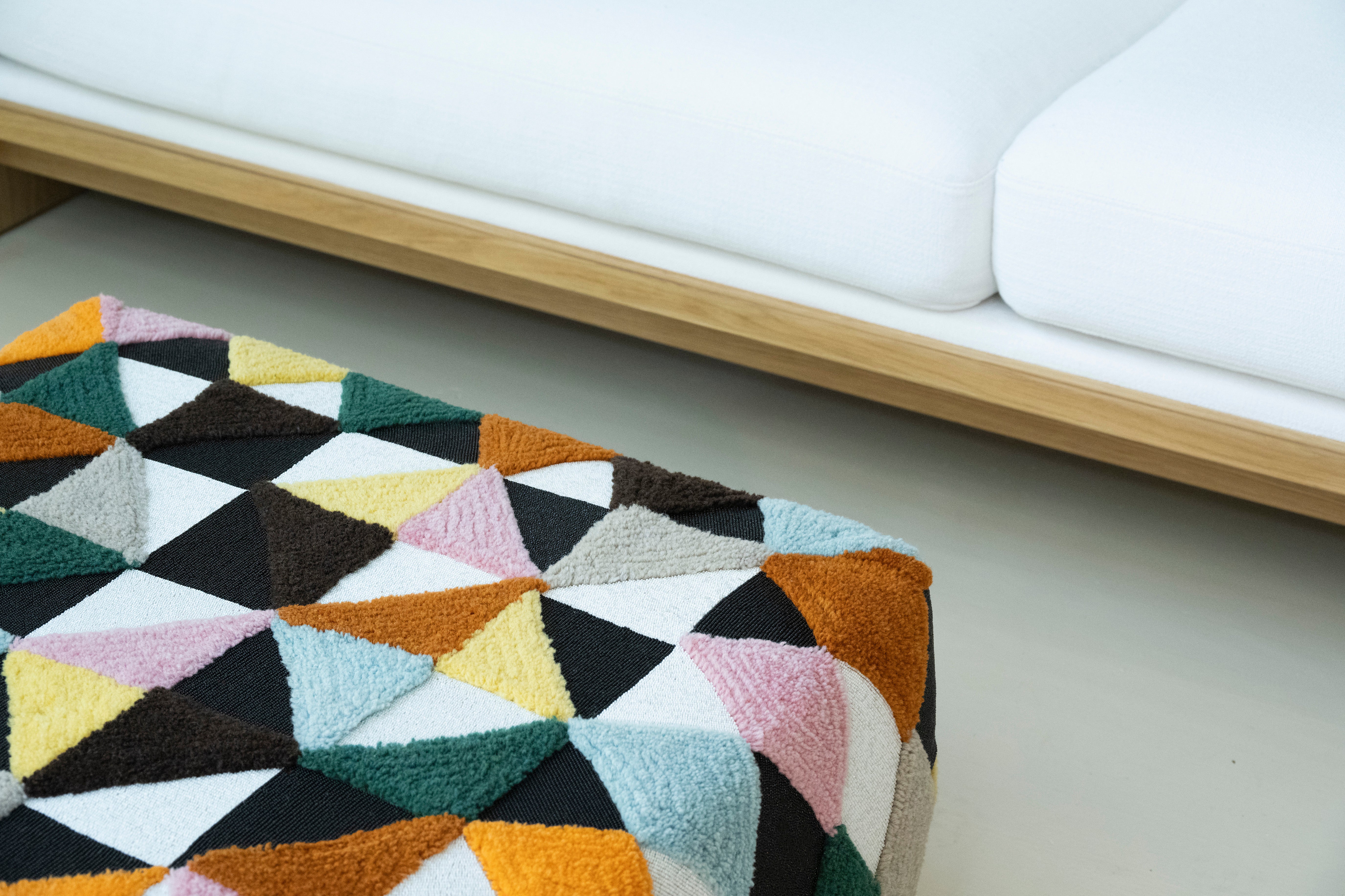 Beaded and tufted embellished square pouff, close up view