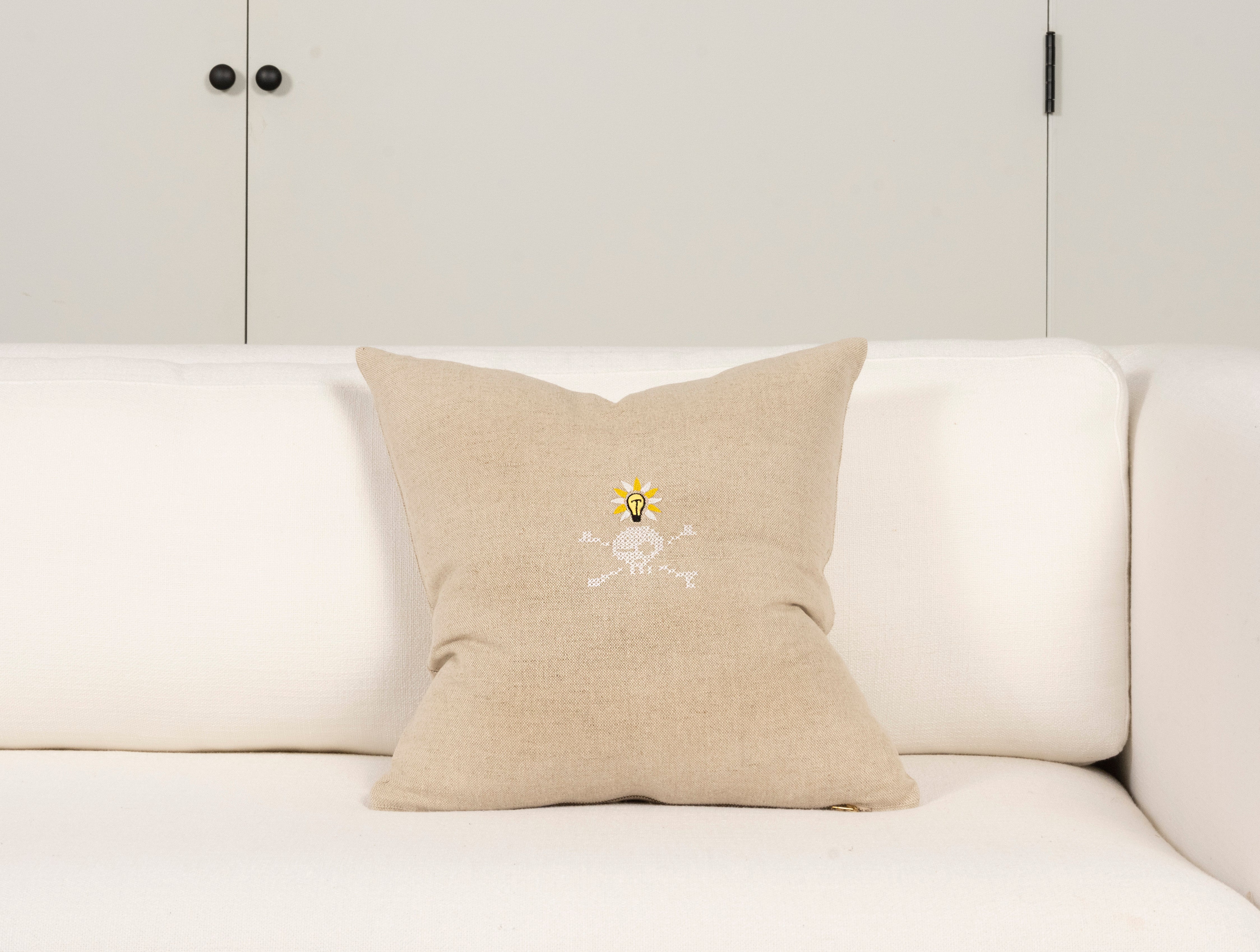 Pillow with embroidery embellishments, back view 