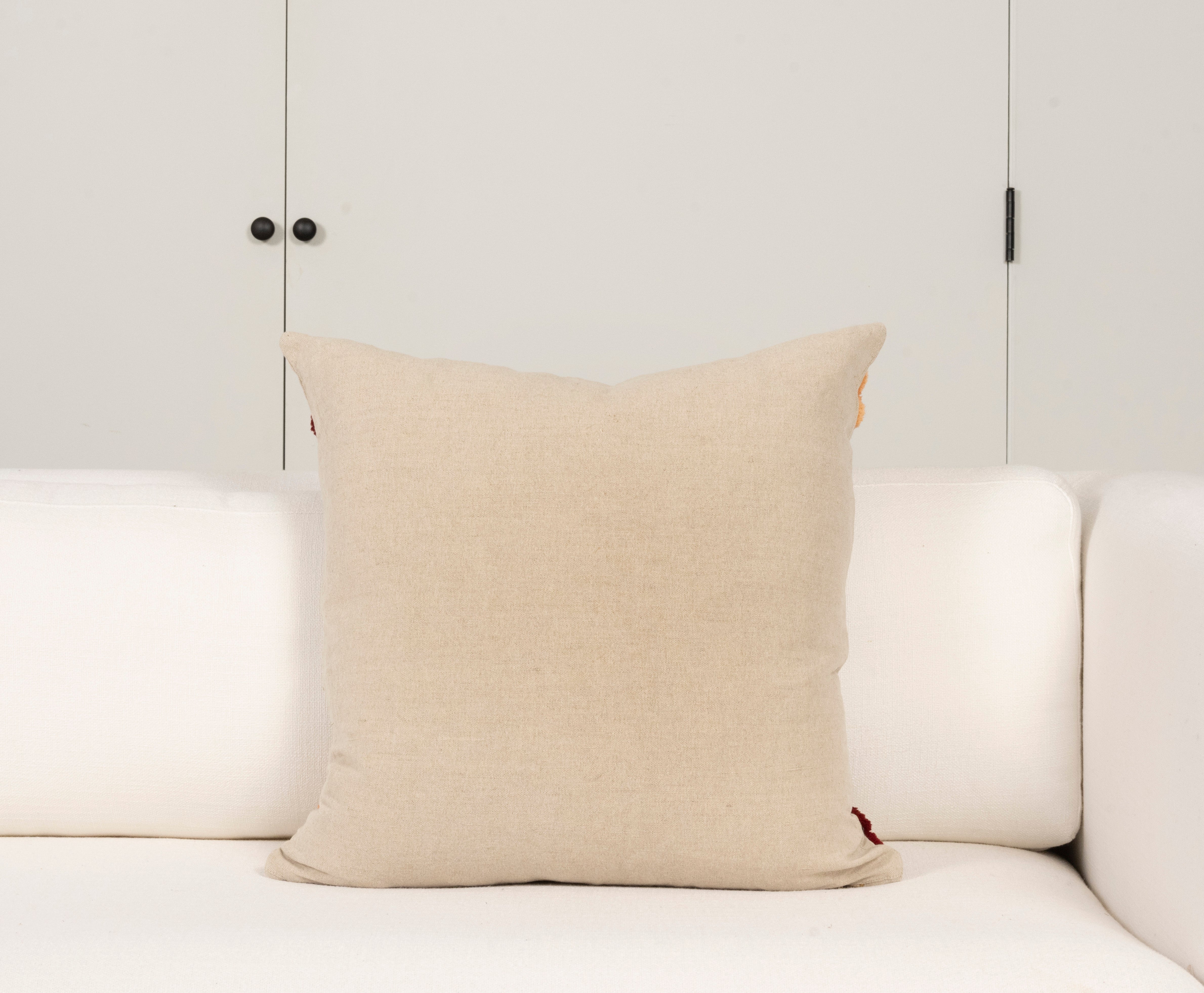 Pillow with embroidery embellishments, back view 