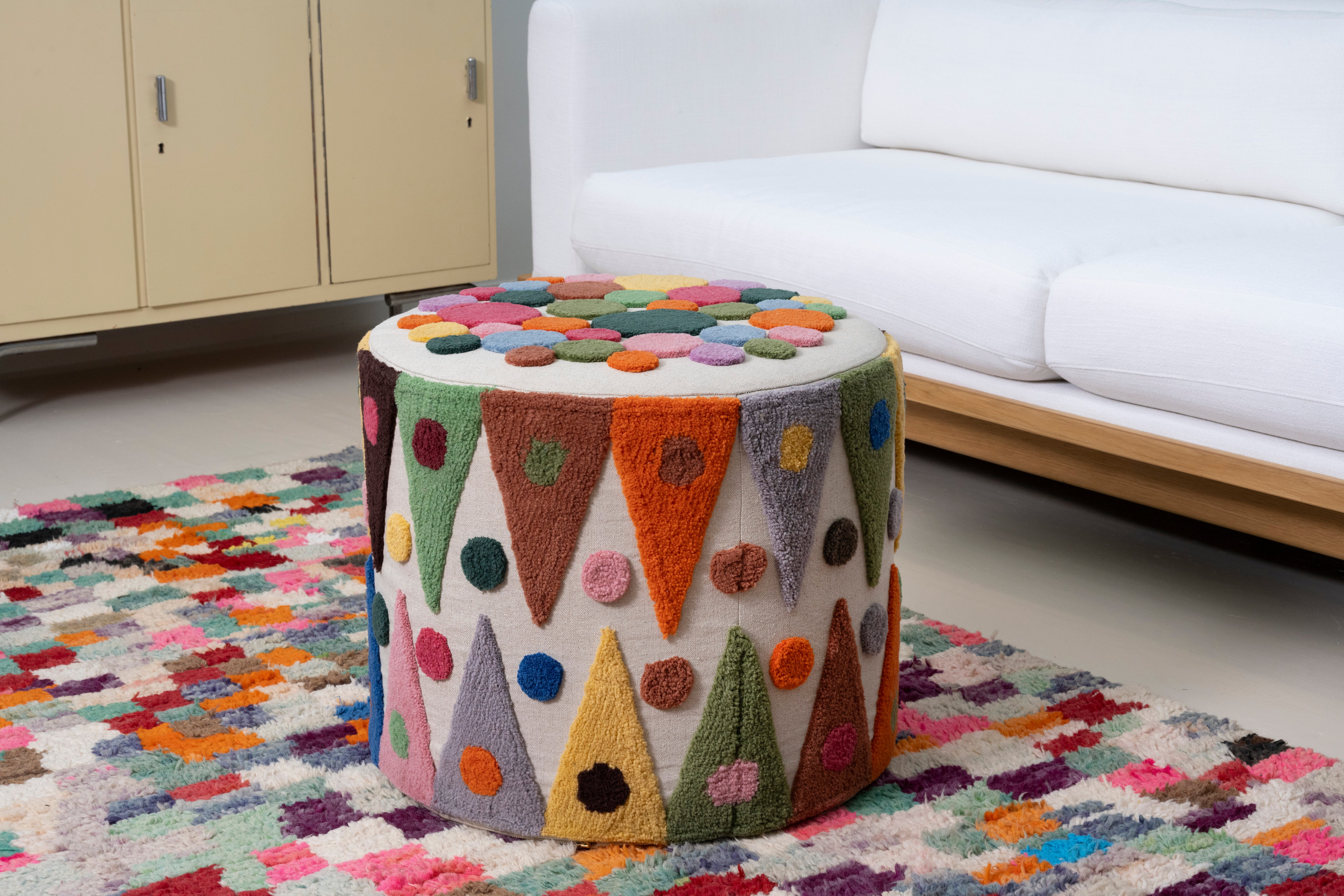 Pouff with tufted embellishment, in living room view