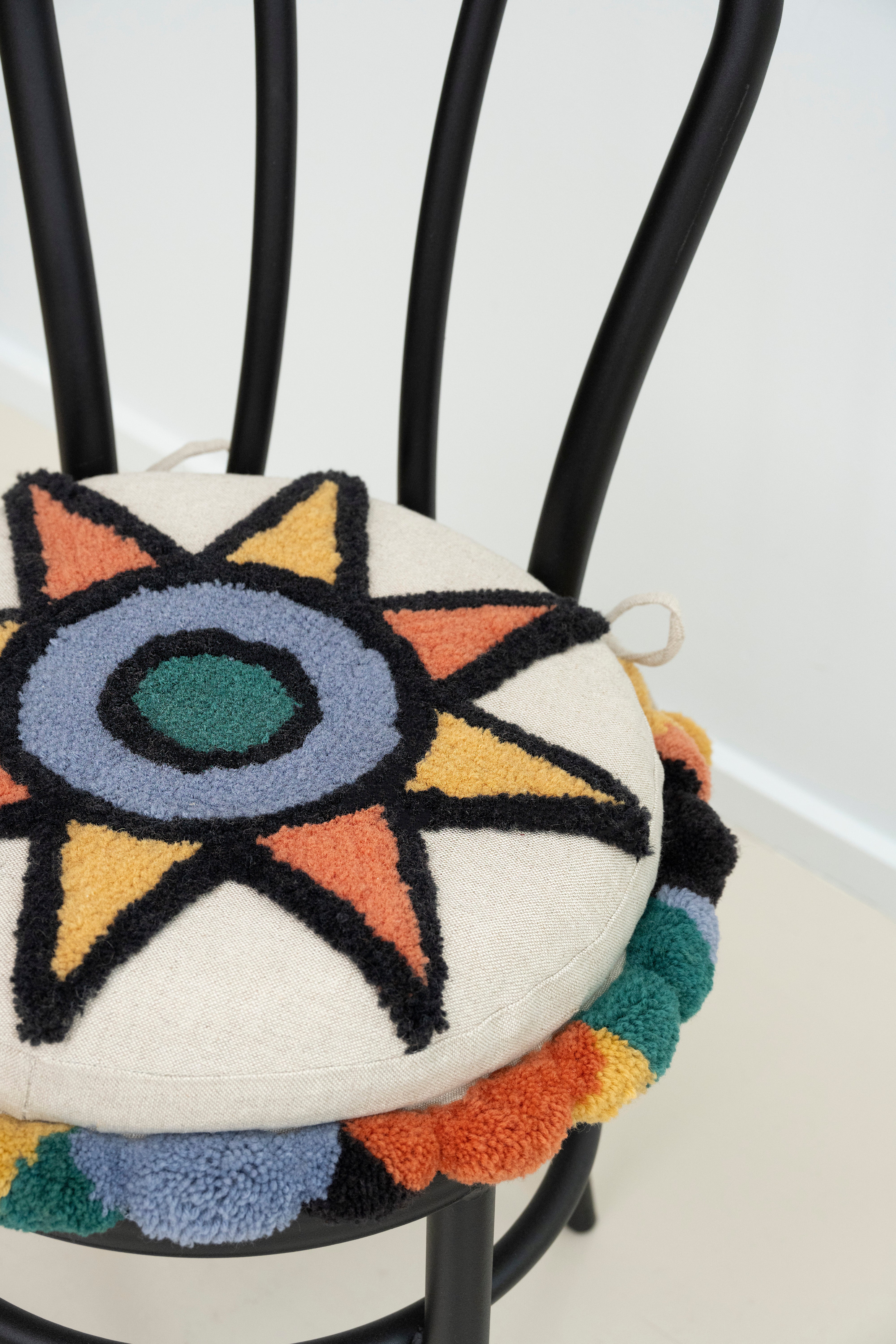 Upcycled chair with tufted embellishments, close up view 