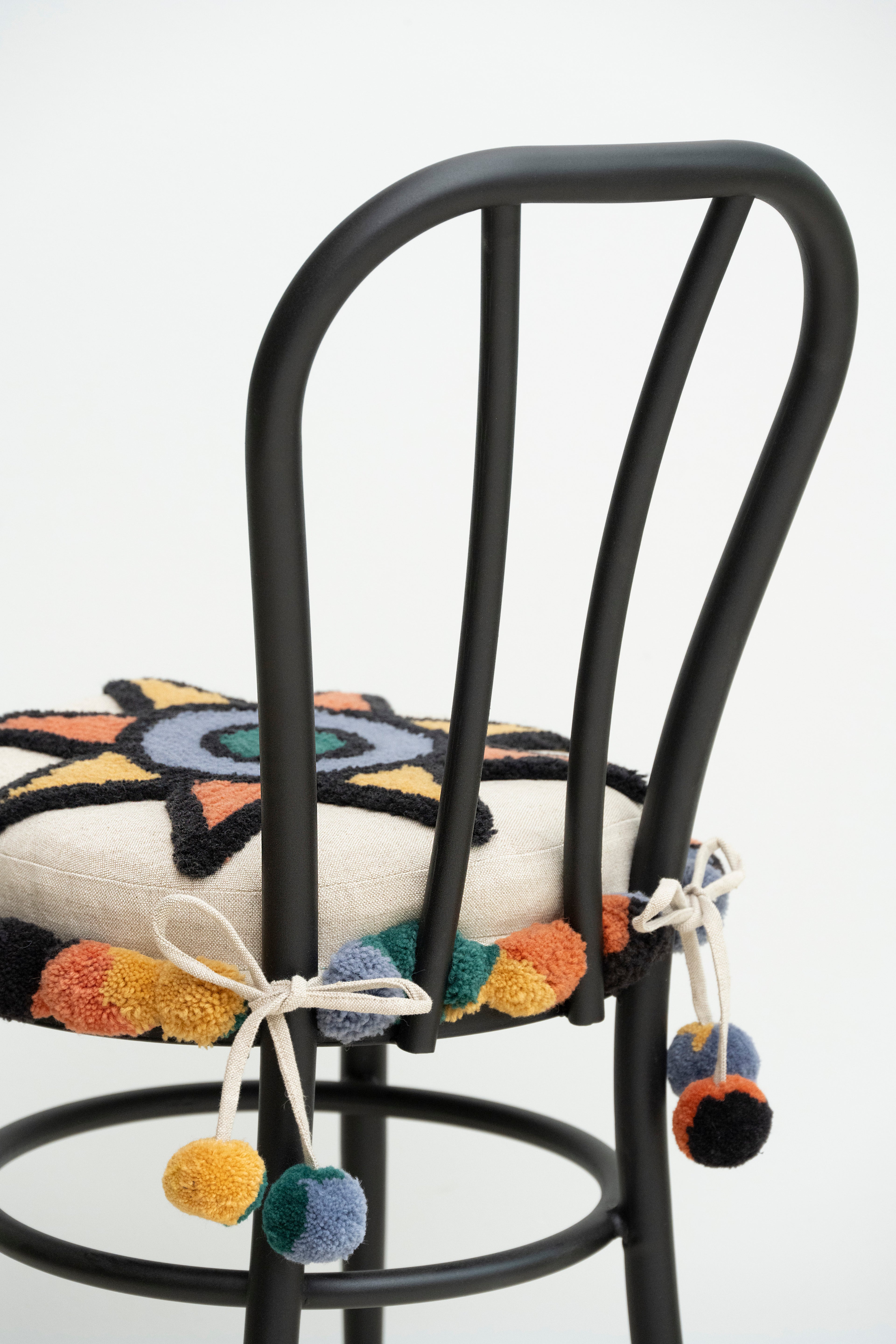 Upcycled chair with tufted embellishments, close up view 