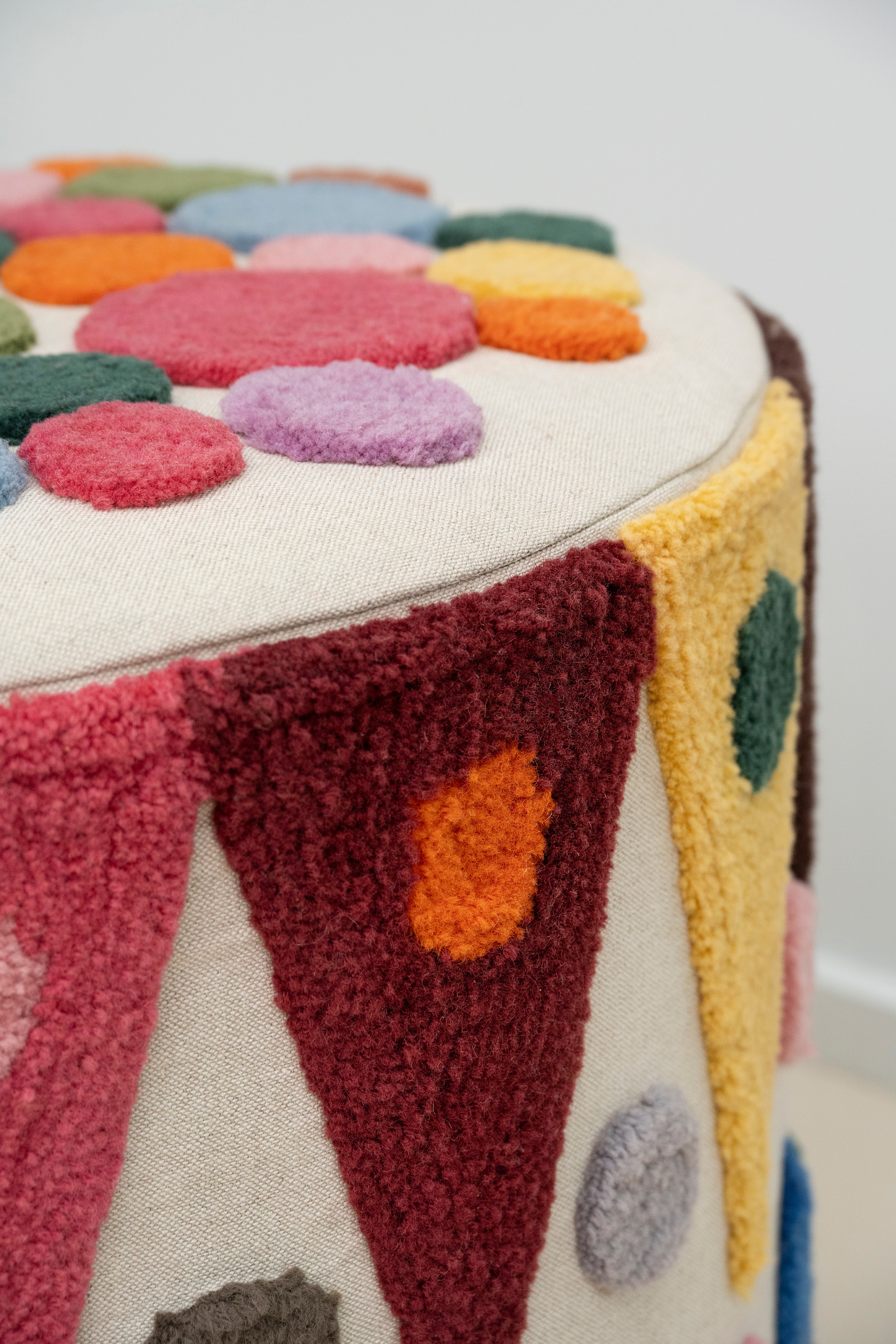 Pouff with tufted embellishment, close up view