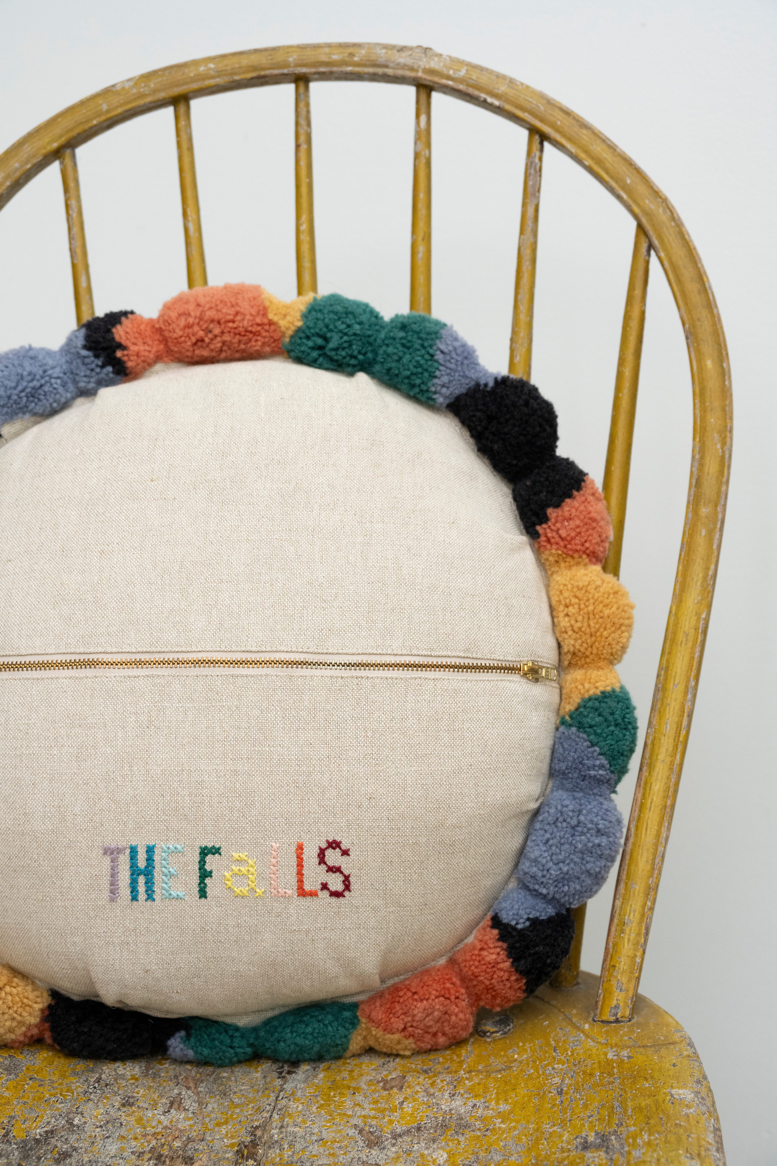 Pillow with tufted embellishments, close up back view 