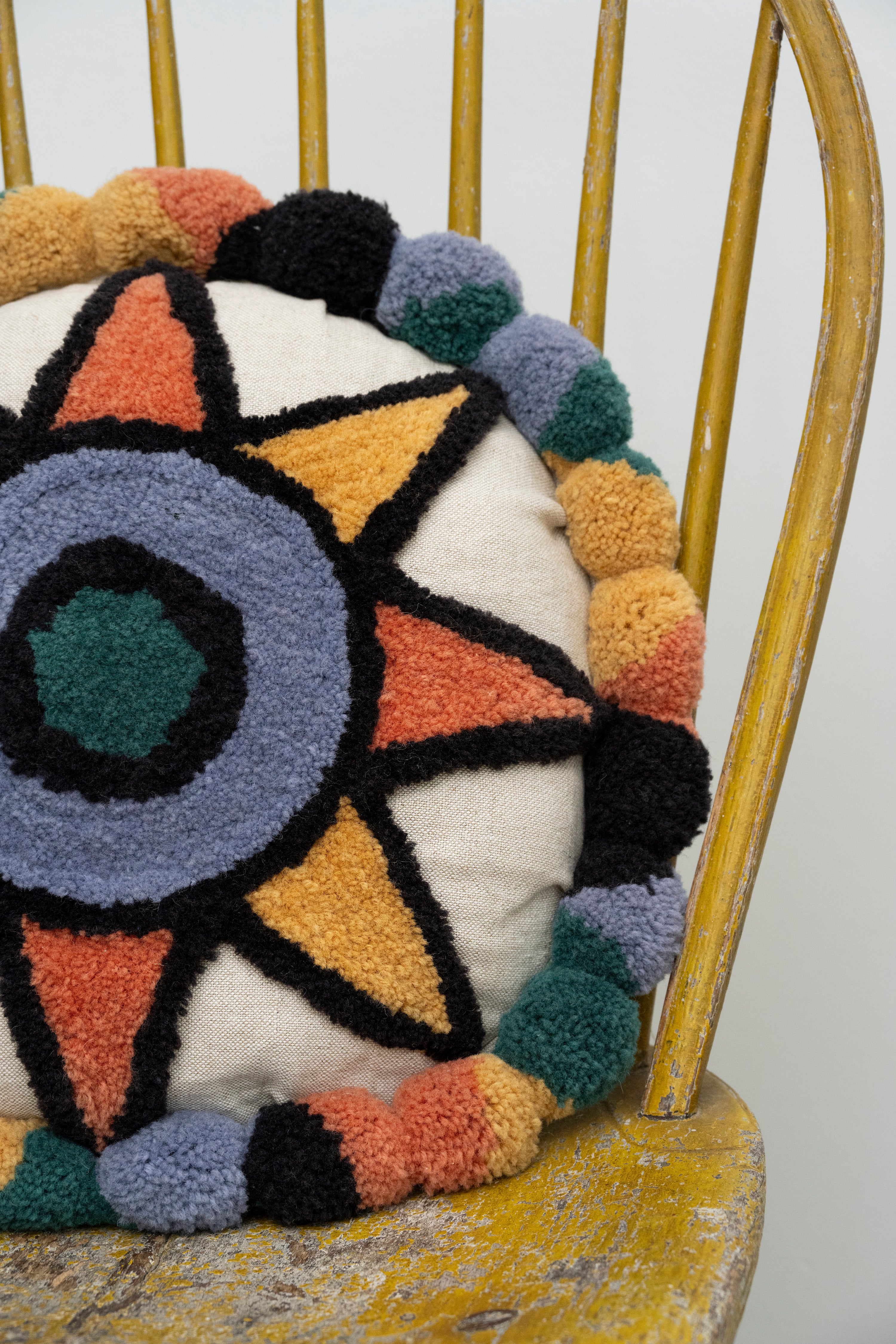 Pillow with tufted embellishments, close up view 