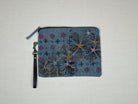 Pouch with embroidered embellishments, front view