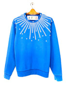 Upcycled sweatshirt with pearl button embellishments, front view