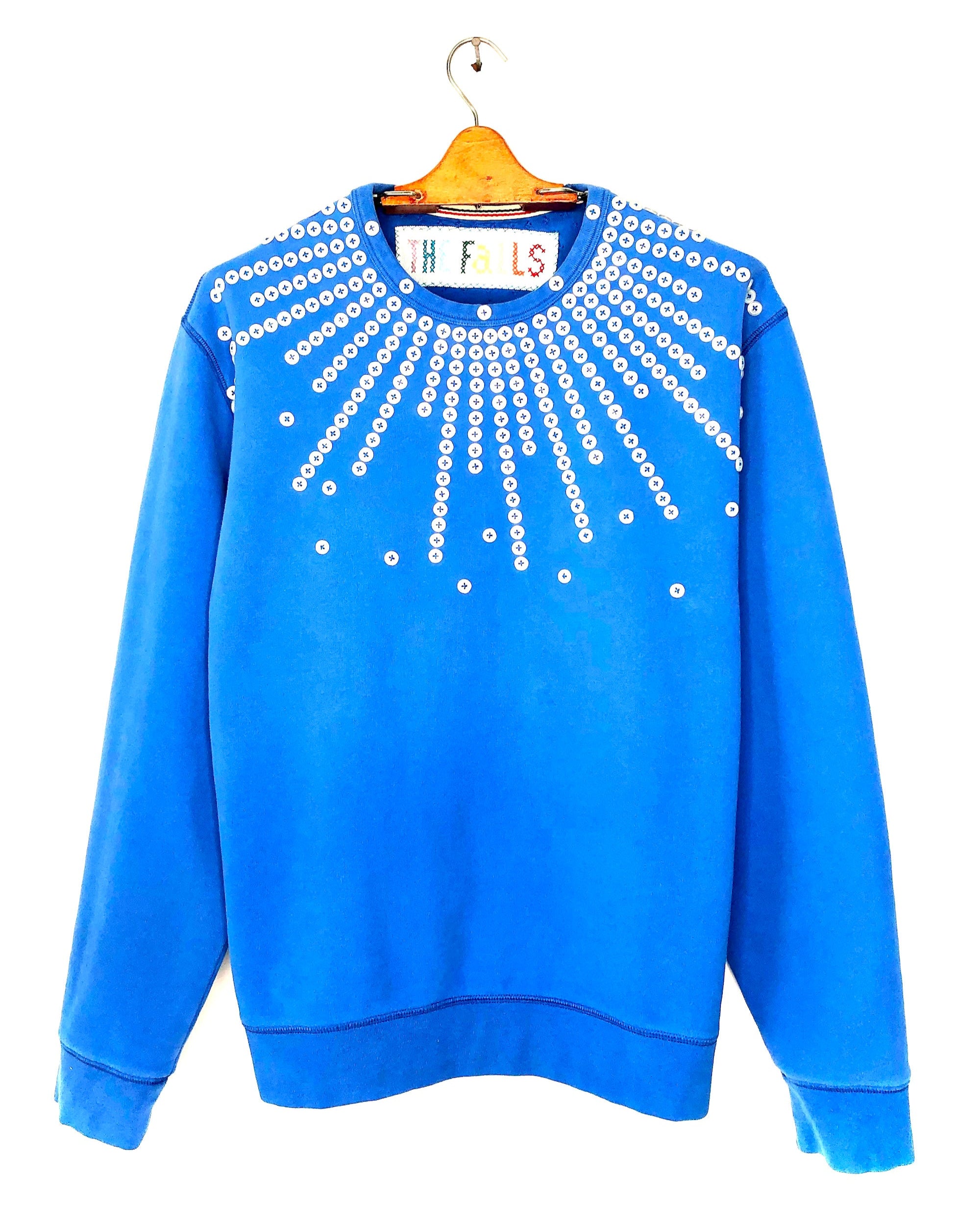 Upcycled sweatshirt with pearl button embellishments, front view