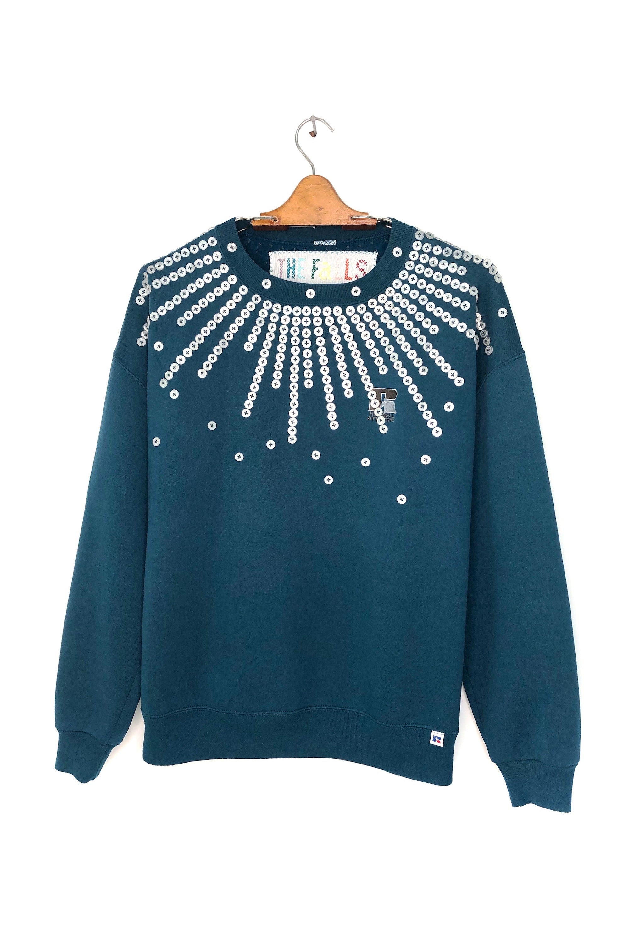 Upcycled sweatshirt with pearl button embellishments, front view