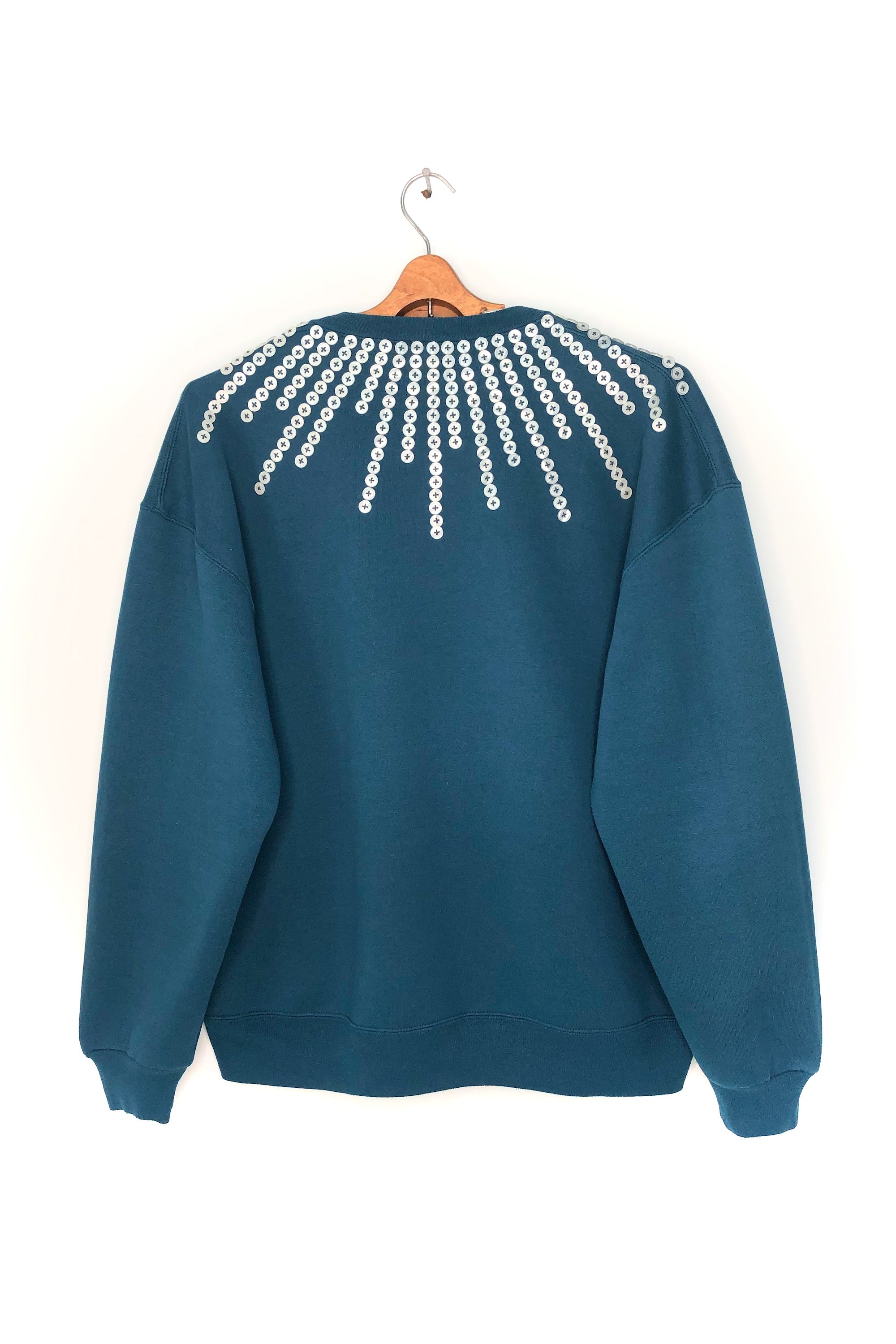 Upcycled sweatshirt with pearl button embellishments, back view