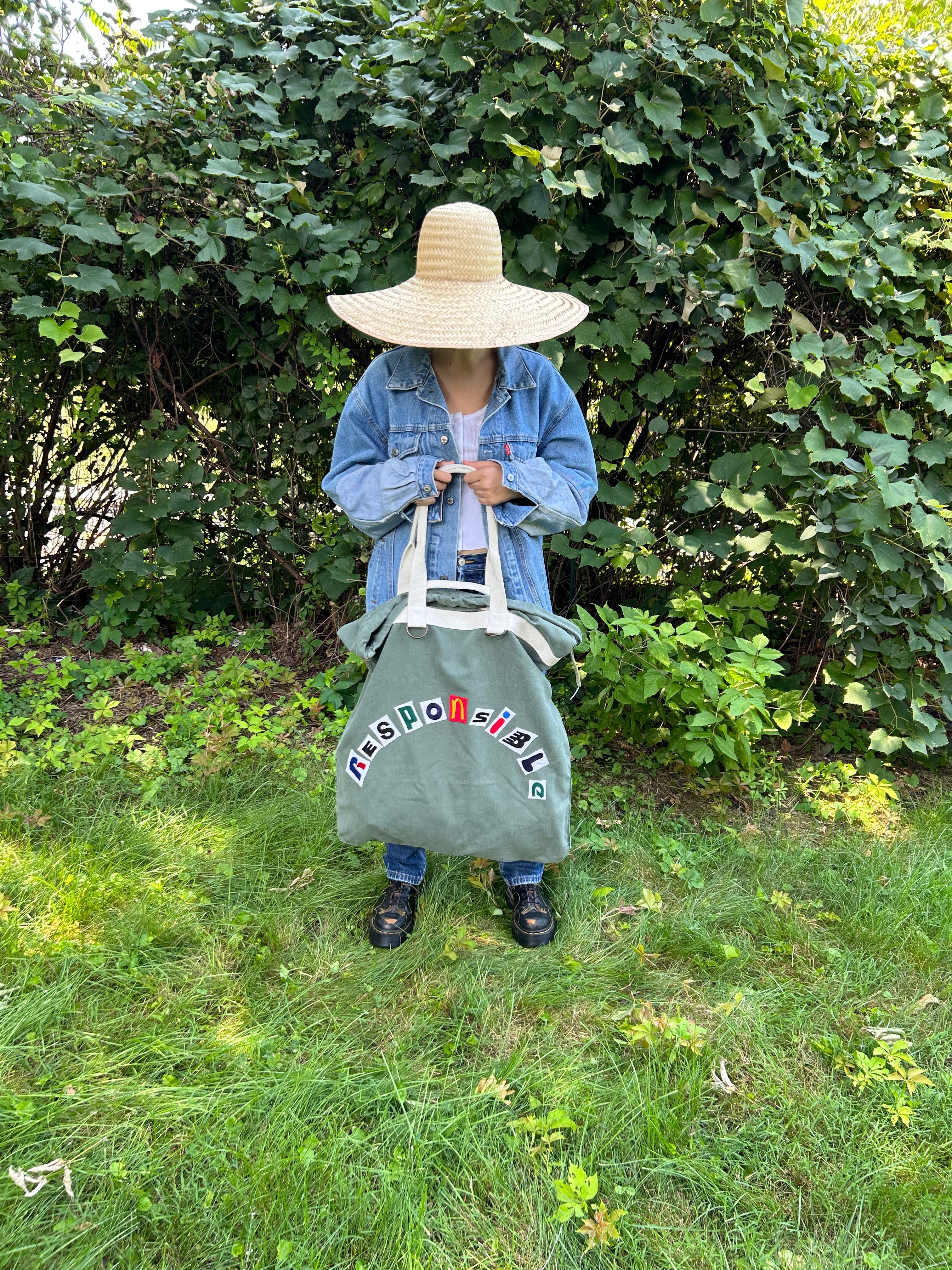 Upcycled army laundry bag with “responsible” text, front view 