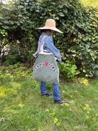Upcycled army laundry bag with “responsible” text, front view 
