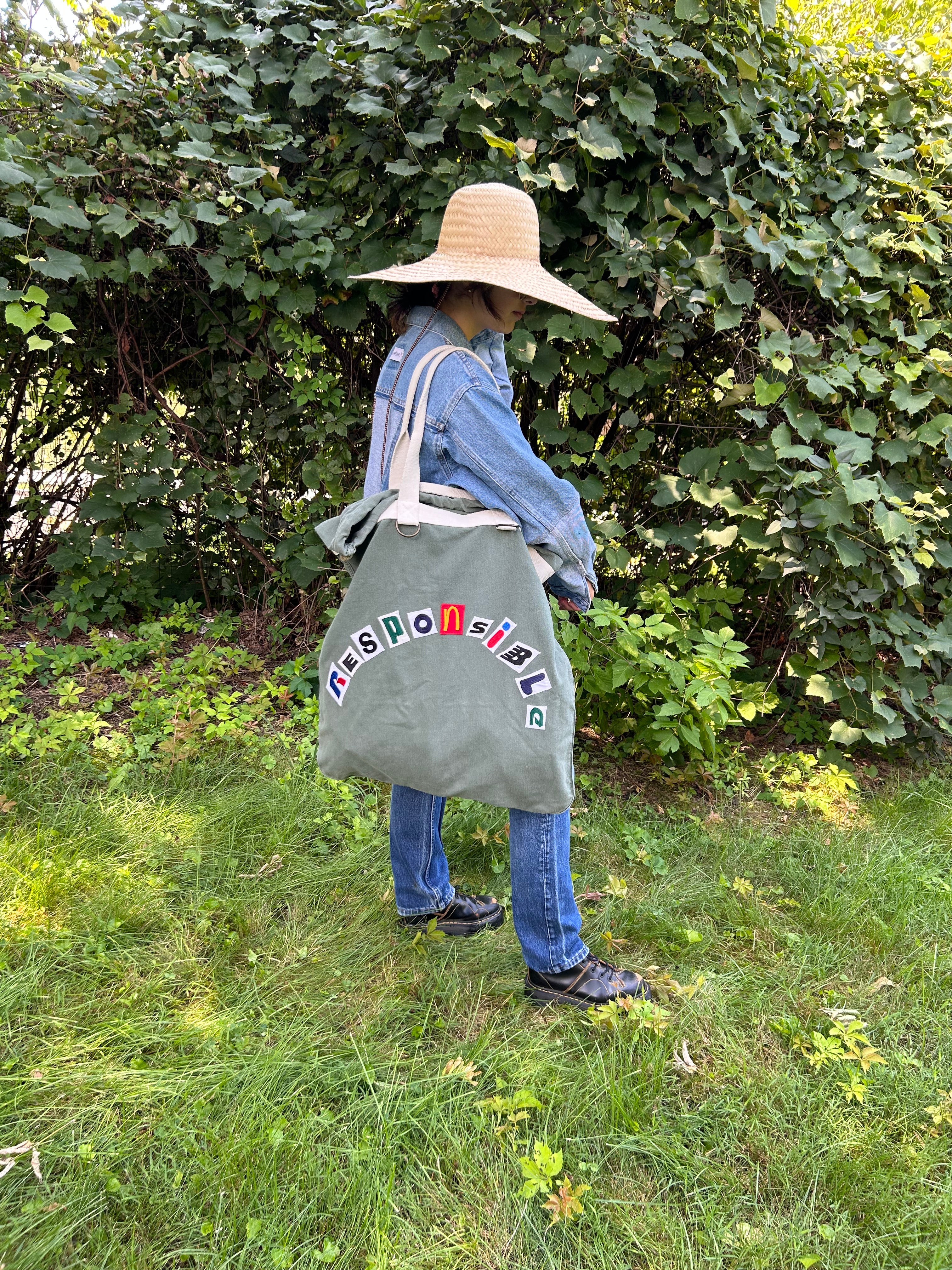 Upcycled army laundry bag with “responsible” text, front view 