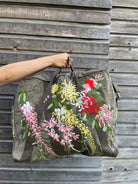 Upcycled aviator bag with embroidered embellishments, front view 