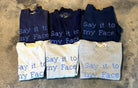 Upcycled sweatshirt with embroidery saying  “Say it to my face”, collection view. 