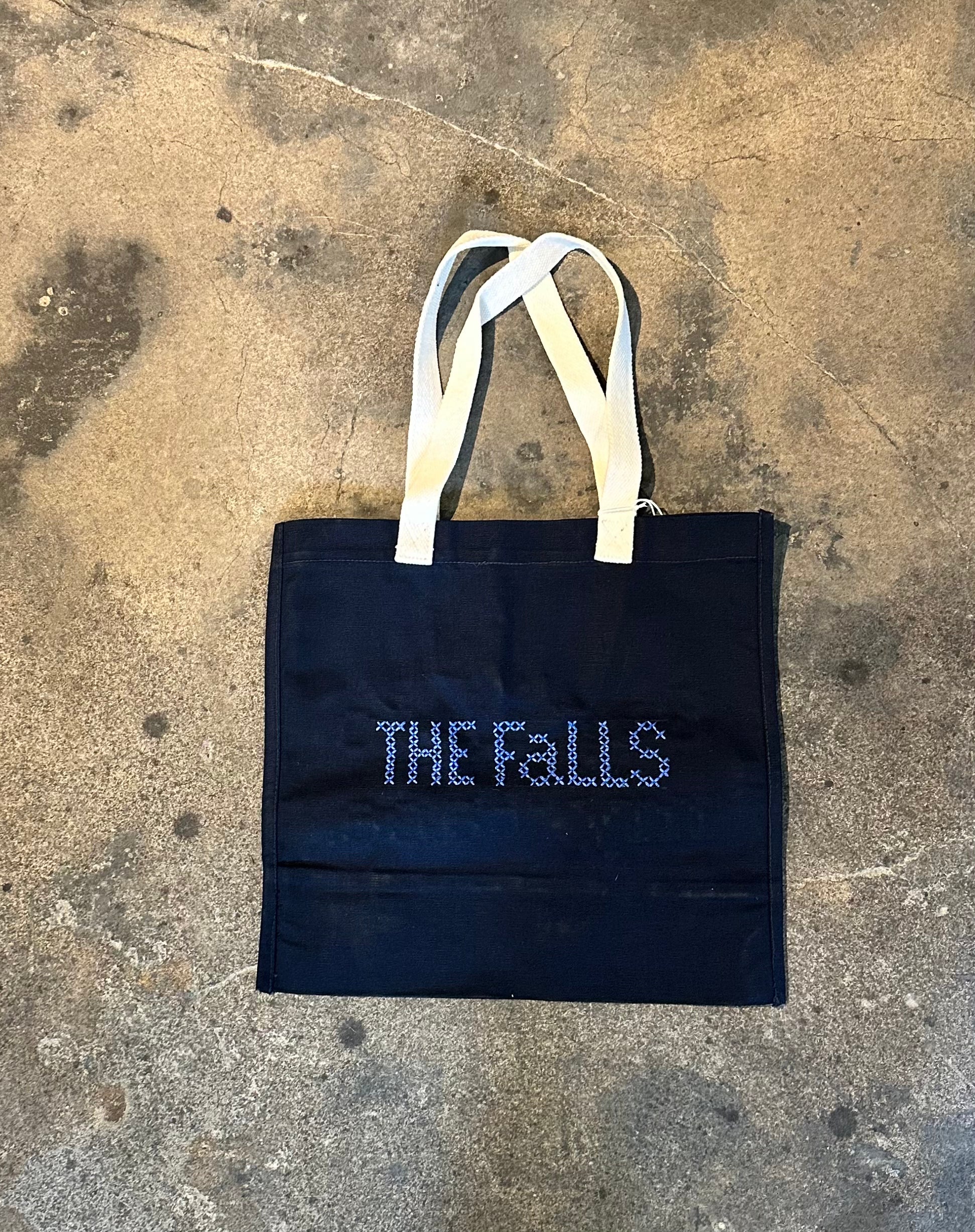 Bag with “Say it to my face” embroidered in cross stitch, back view.