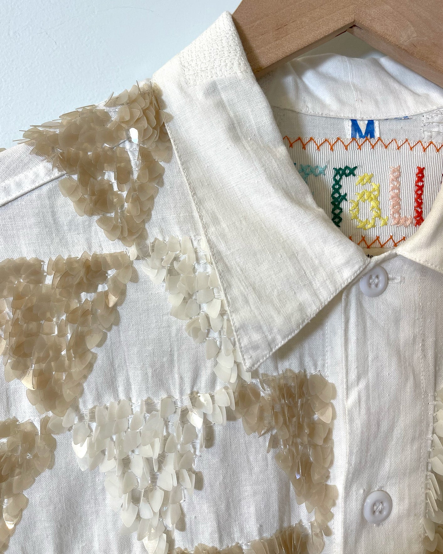 Upcycled t-shirt with sequin embellishments, close up view