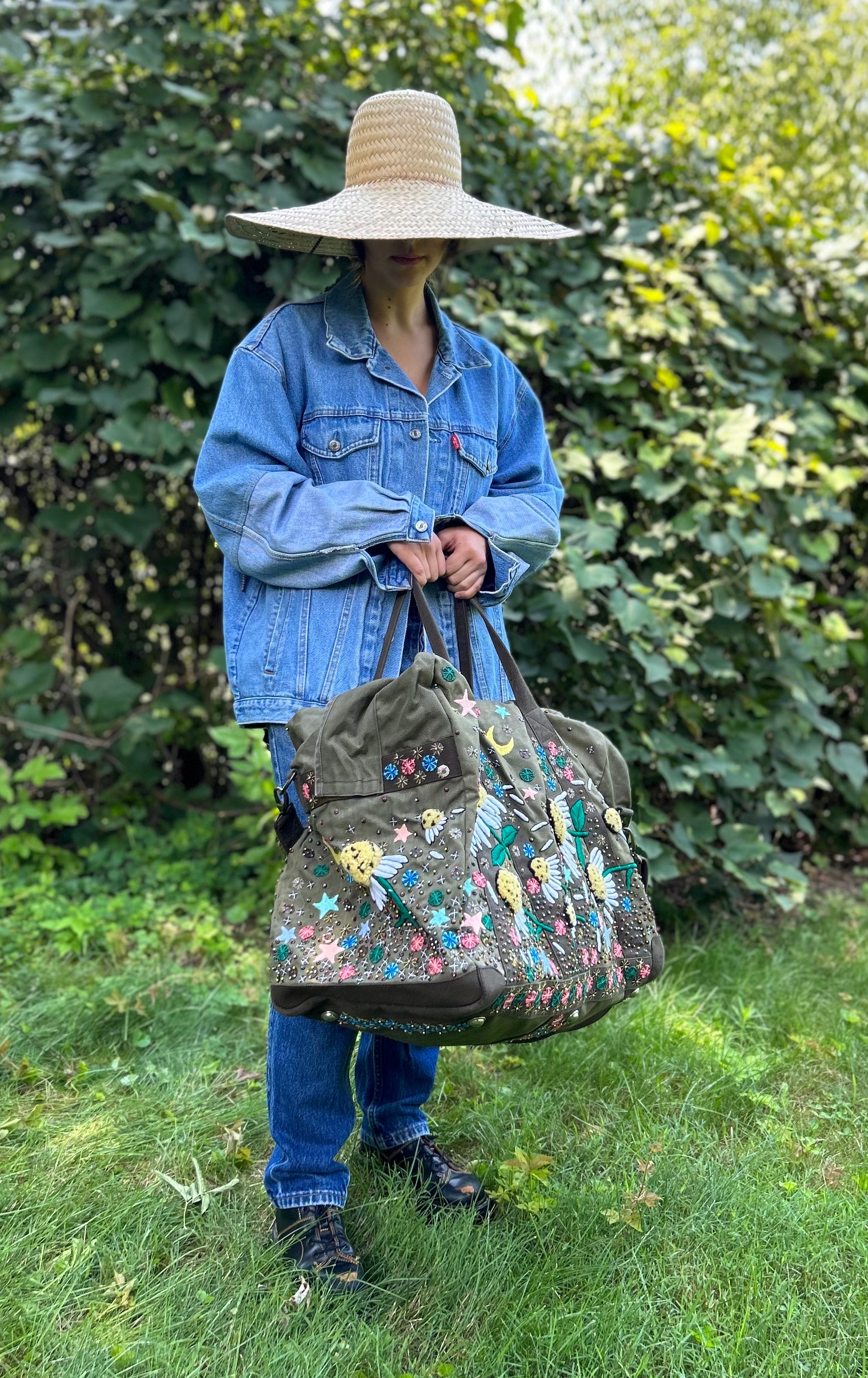 Upcycled aviator bag with embroidered embellishments, side view 