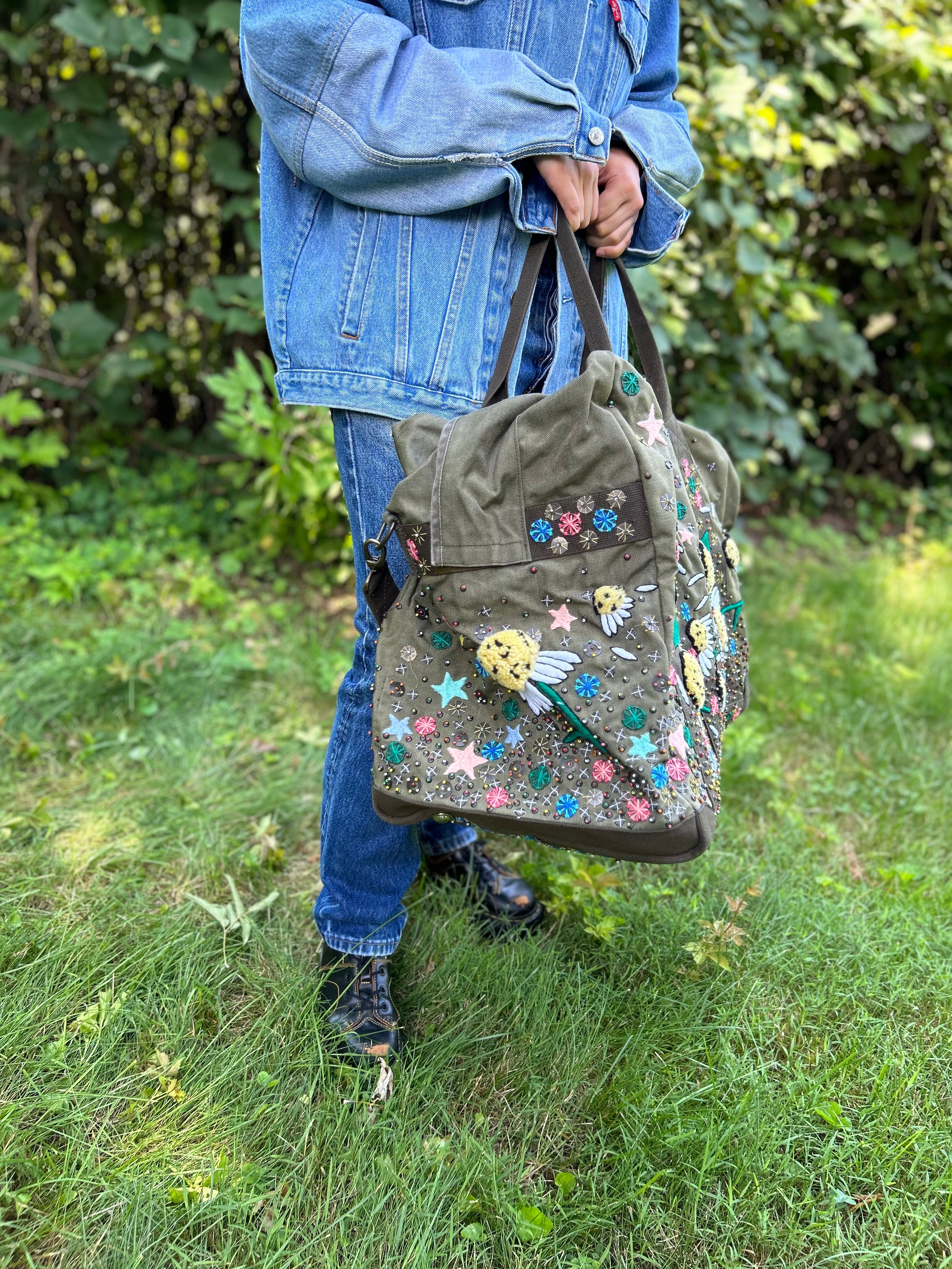 Upcycled aviator bag with embroidered embellishments, side view 
