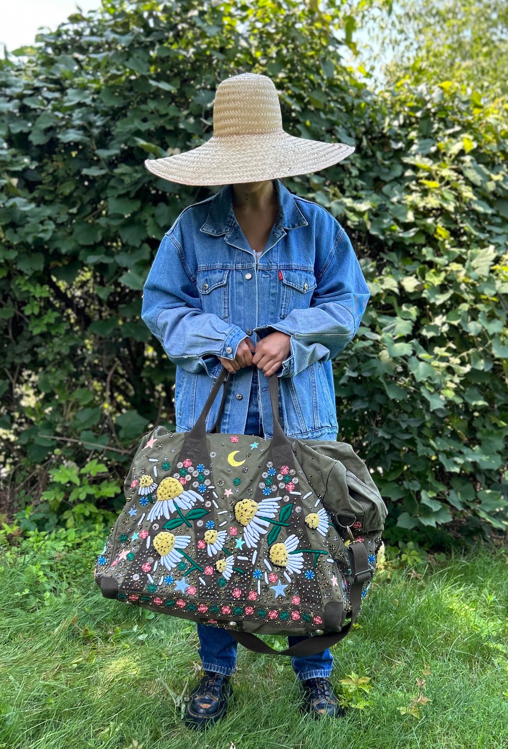 Upcycled aviator bag with embroidered embellishments, front view 