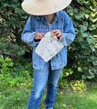 Pouch with embroidered and button embellishments, back view