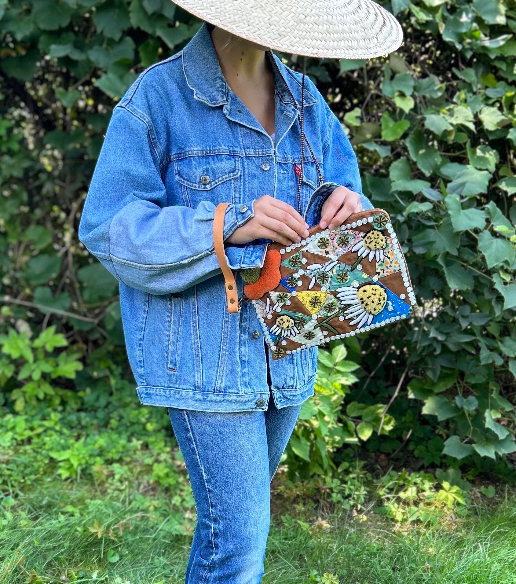 Pouch with embroidered and button embellishments, front view