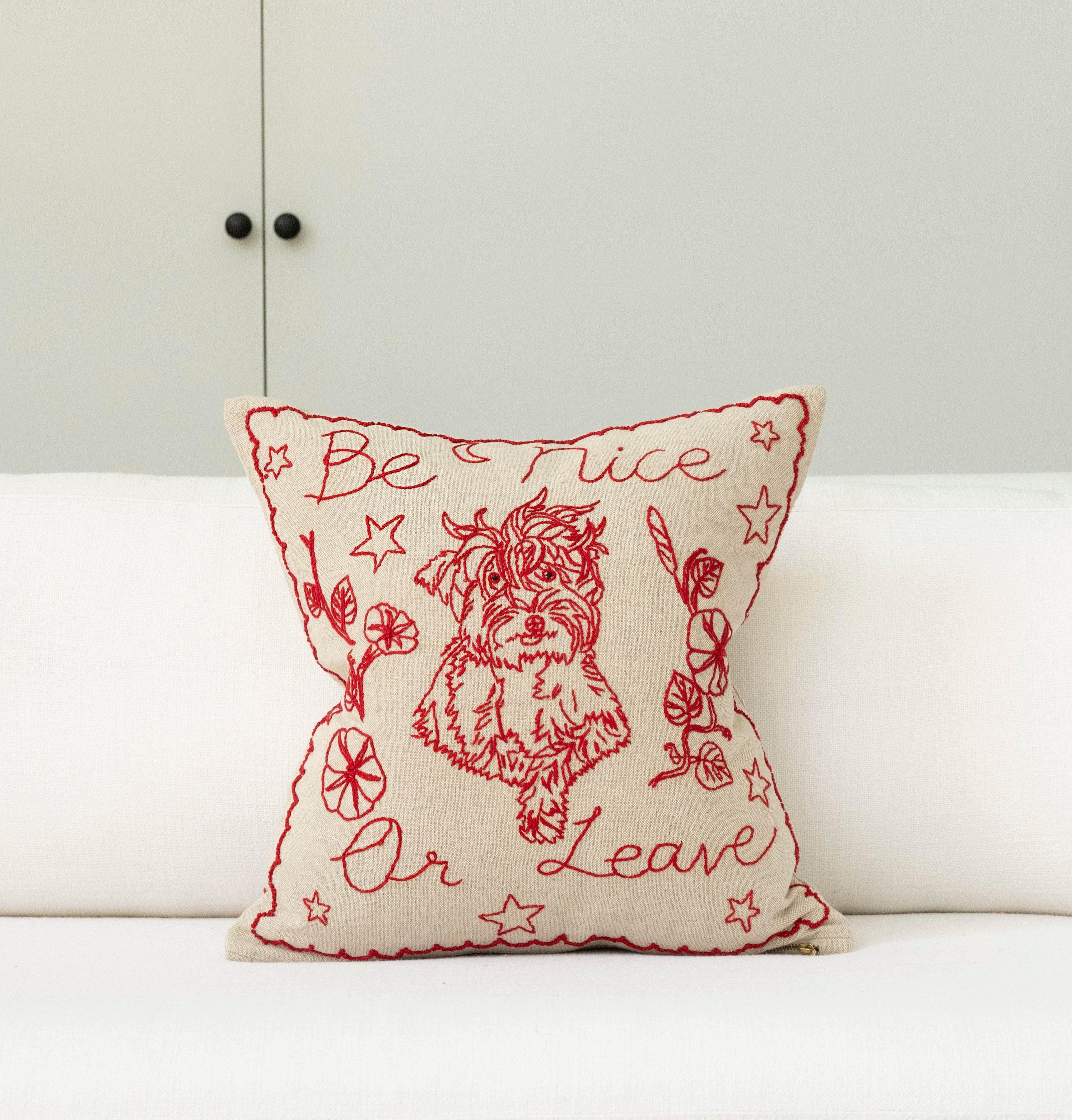 Pillow with embroidery embellishments, font view 