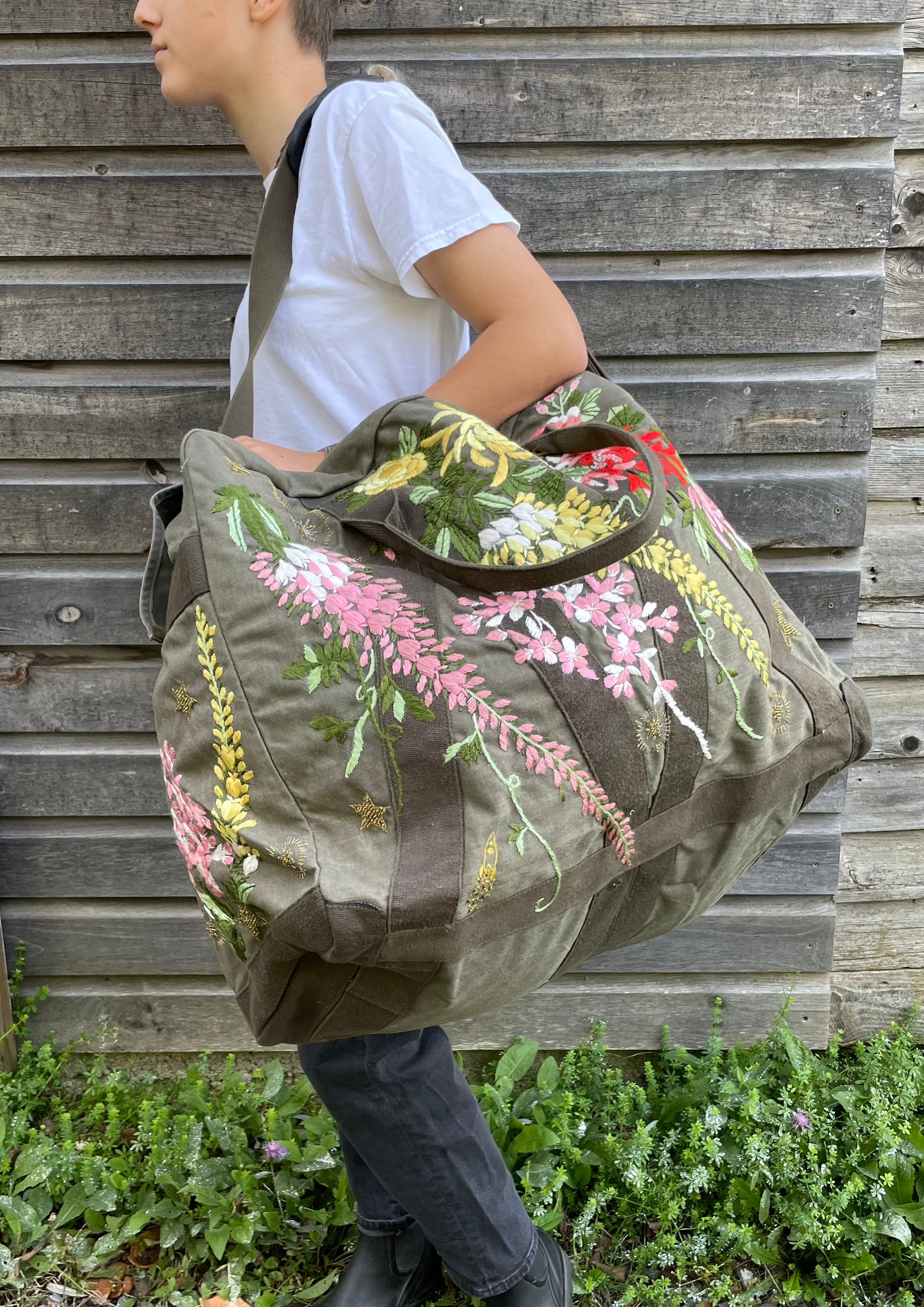 Upcycled aviator bag with embroidered embellishments, side view 