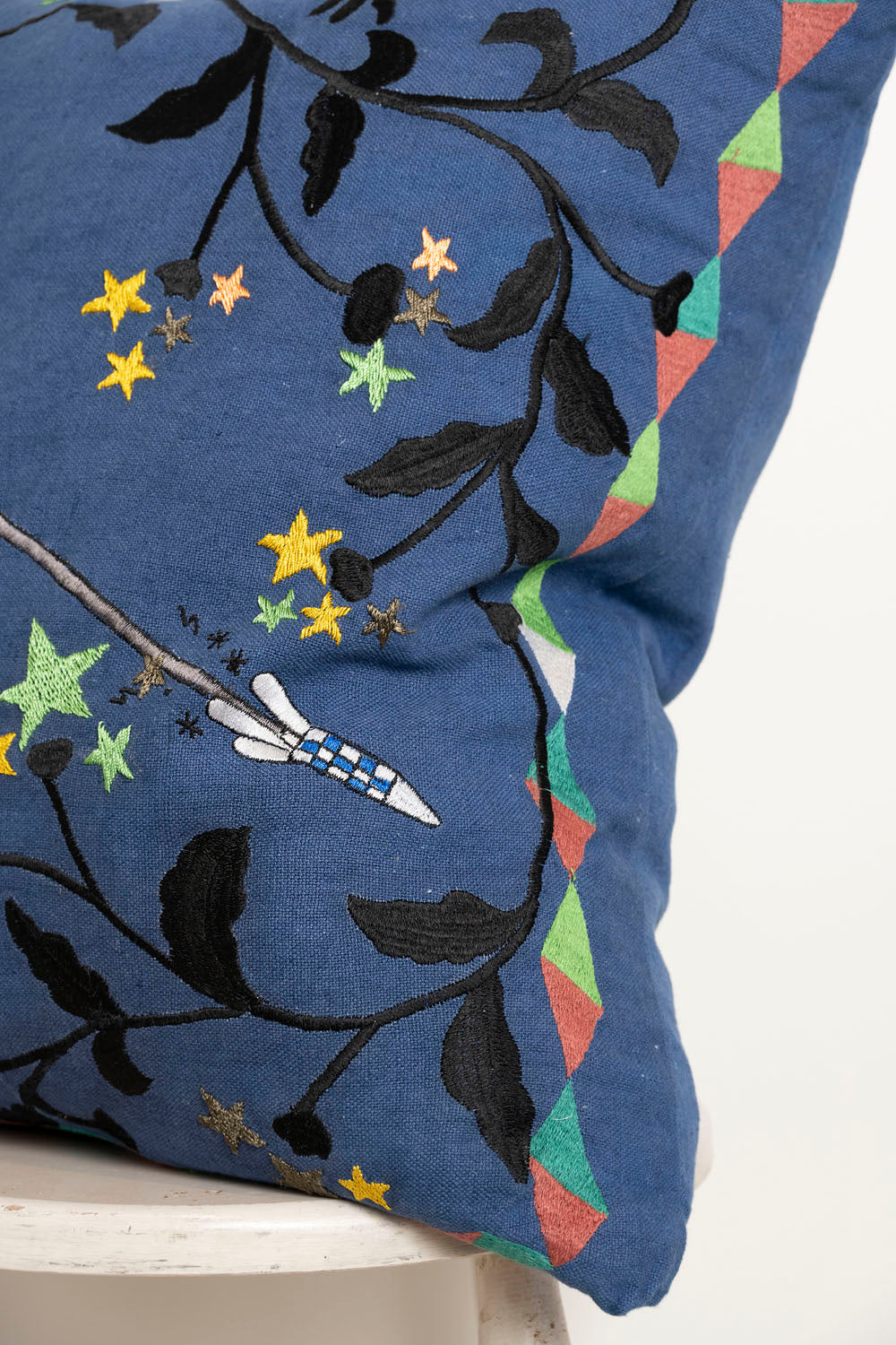 Pillow with embroidery embellishments, close up view 