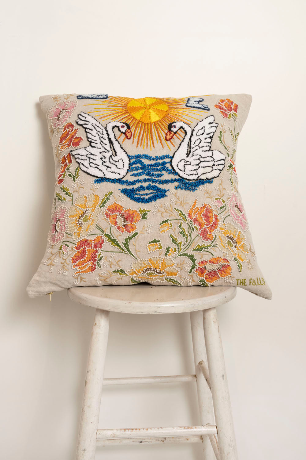 Pillow with embroidery and tufting embellishments, front view 