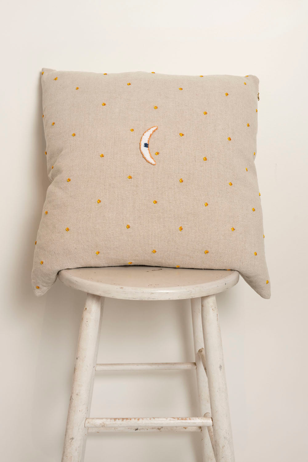 Pillow with embroidery and tufting embellishments, back view 