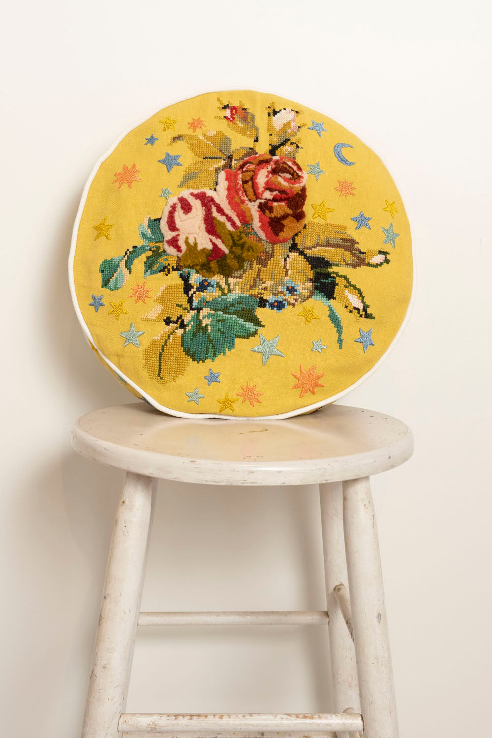 Pillow with embroidery and tufting embellishments, front view 