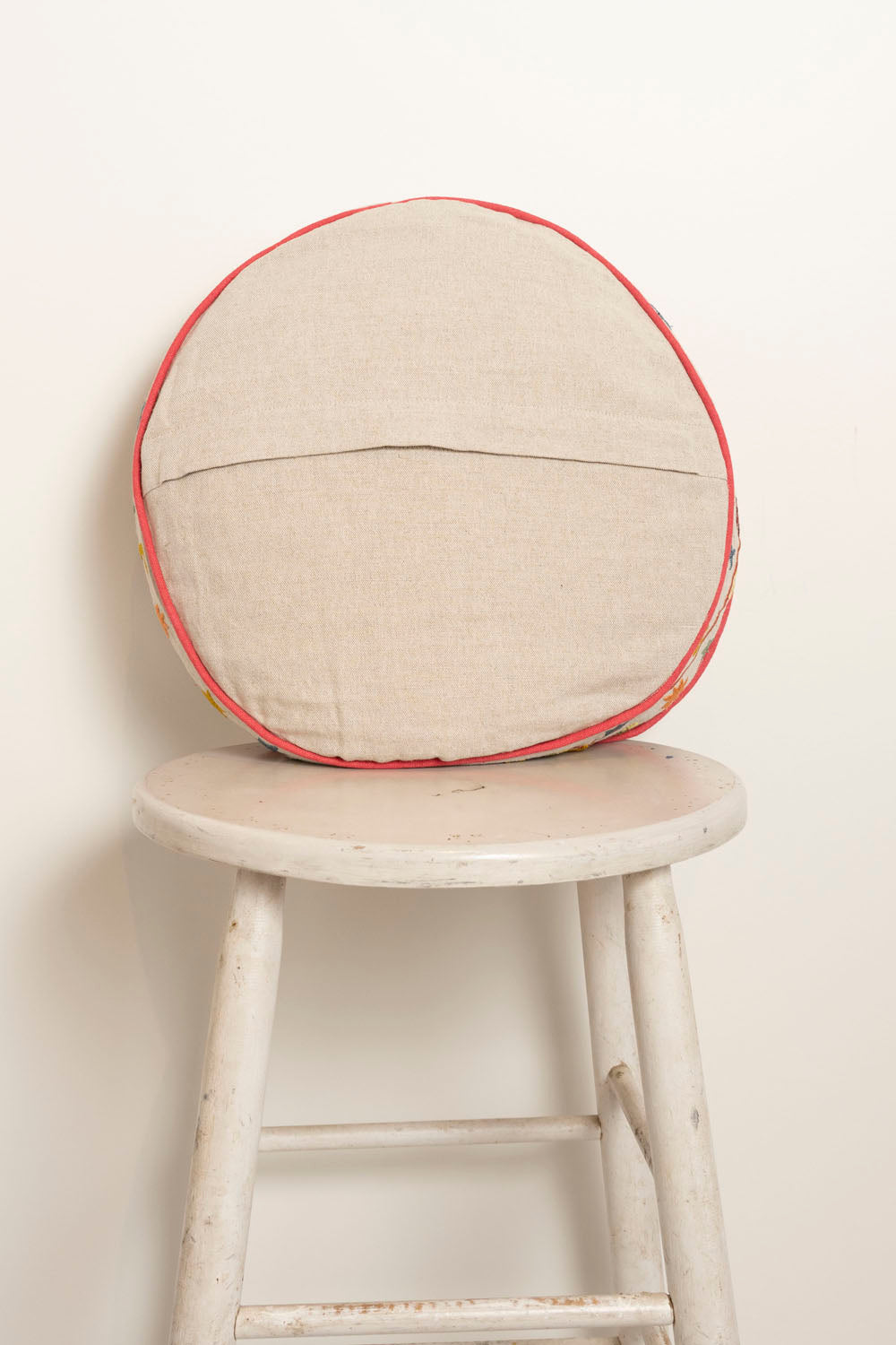 Pillow with embroidery and tufting embellishments, back view 