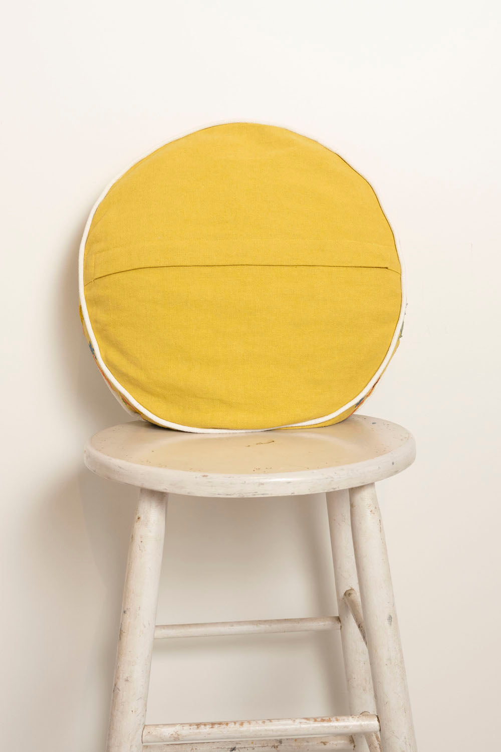 Pillow with embroidery and tufting embellishments, back view 