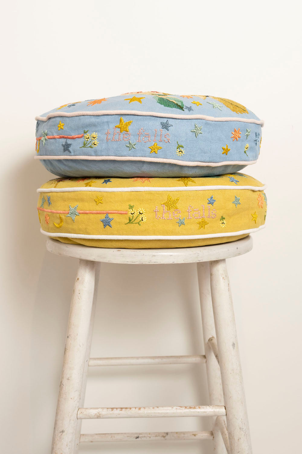 Pillow with embroidery and tufting embellishments, side view 