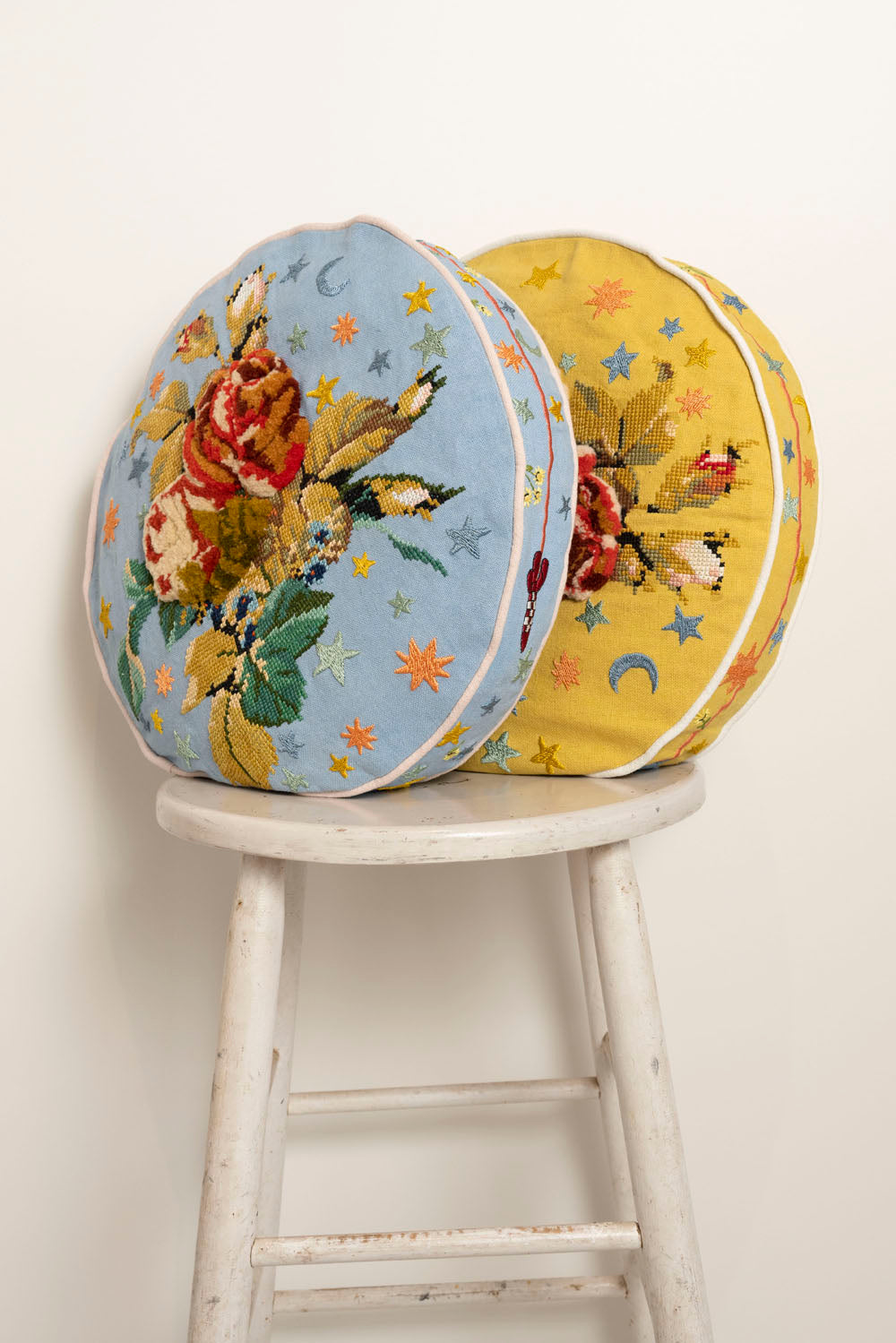 Pillow with embroidery and tufting embellishments, side view 