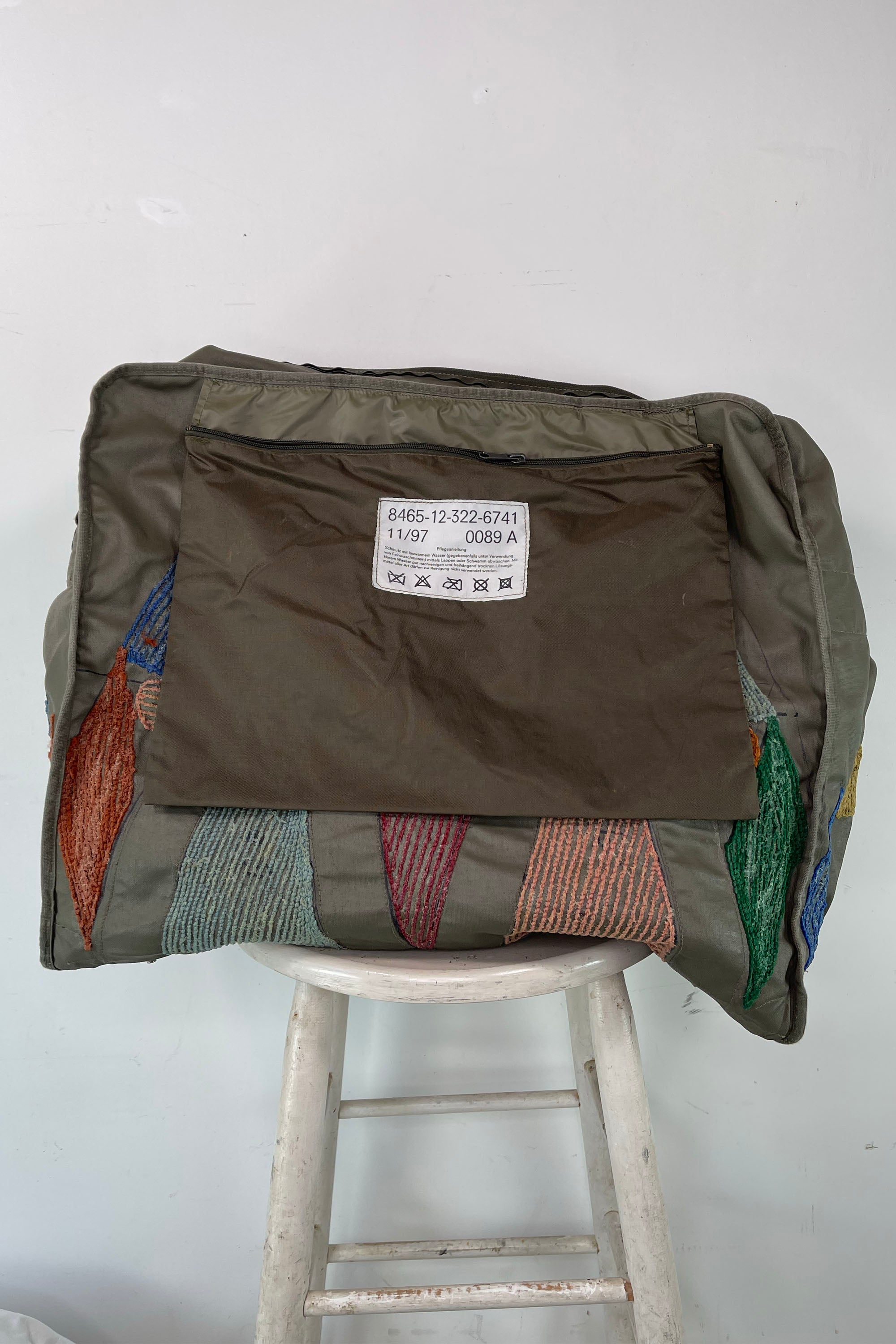 Upcycled aviator bag with tufted embellishments, inside view 