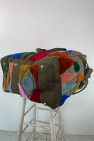 Upcycled aviator bag with tufted embellishments, bottom view 