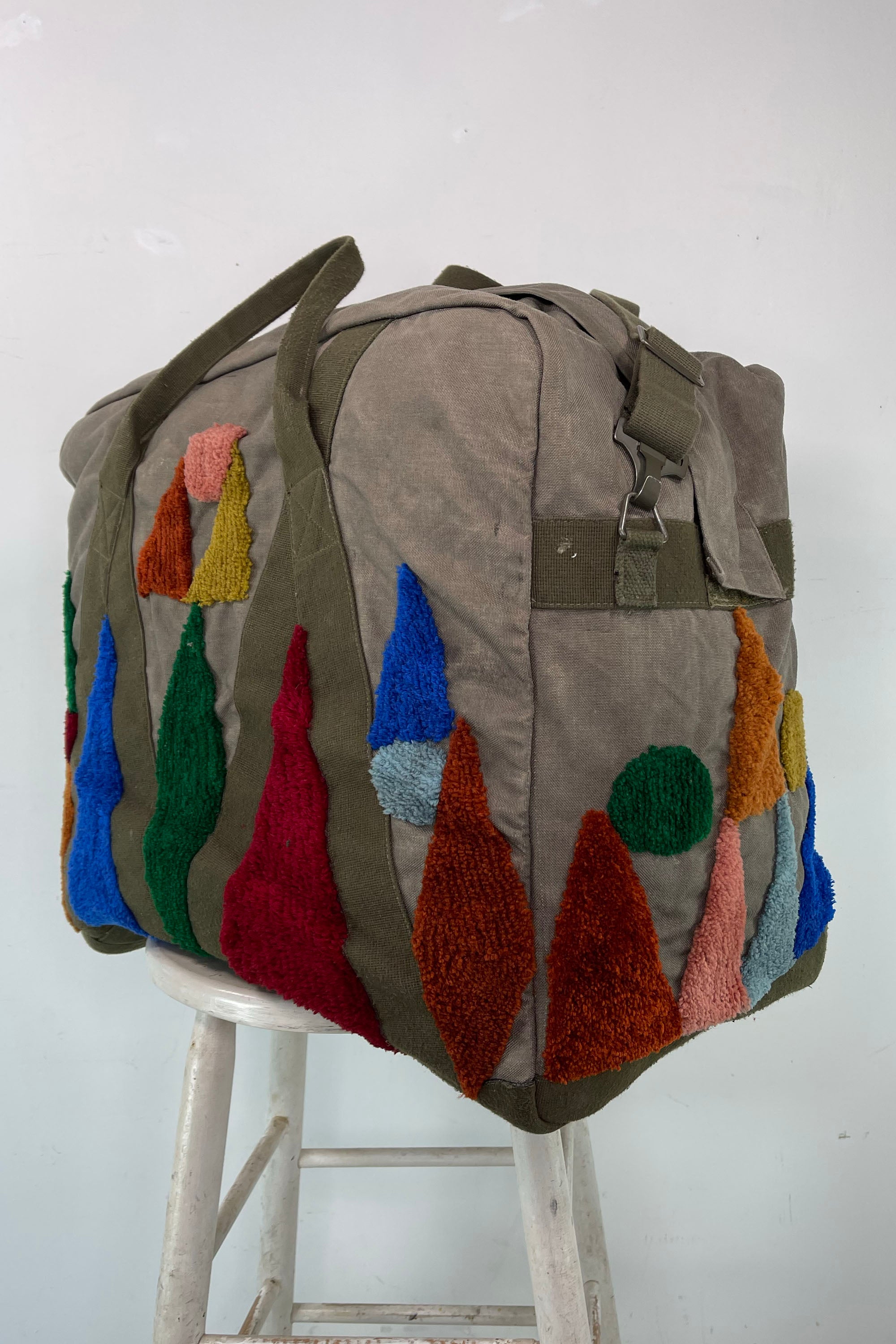 Upcycled aviator bag with tufted embellishments, side view 