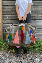 Upcycled aviator bag with tufted embellishments, front view 