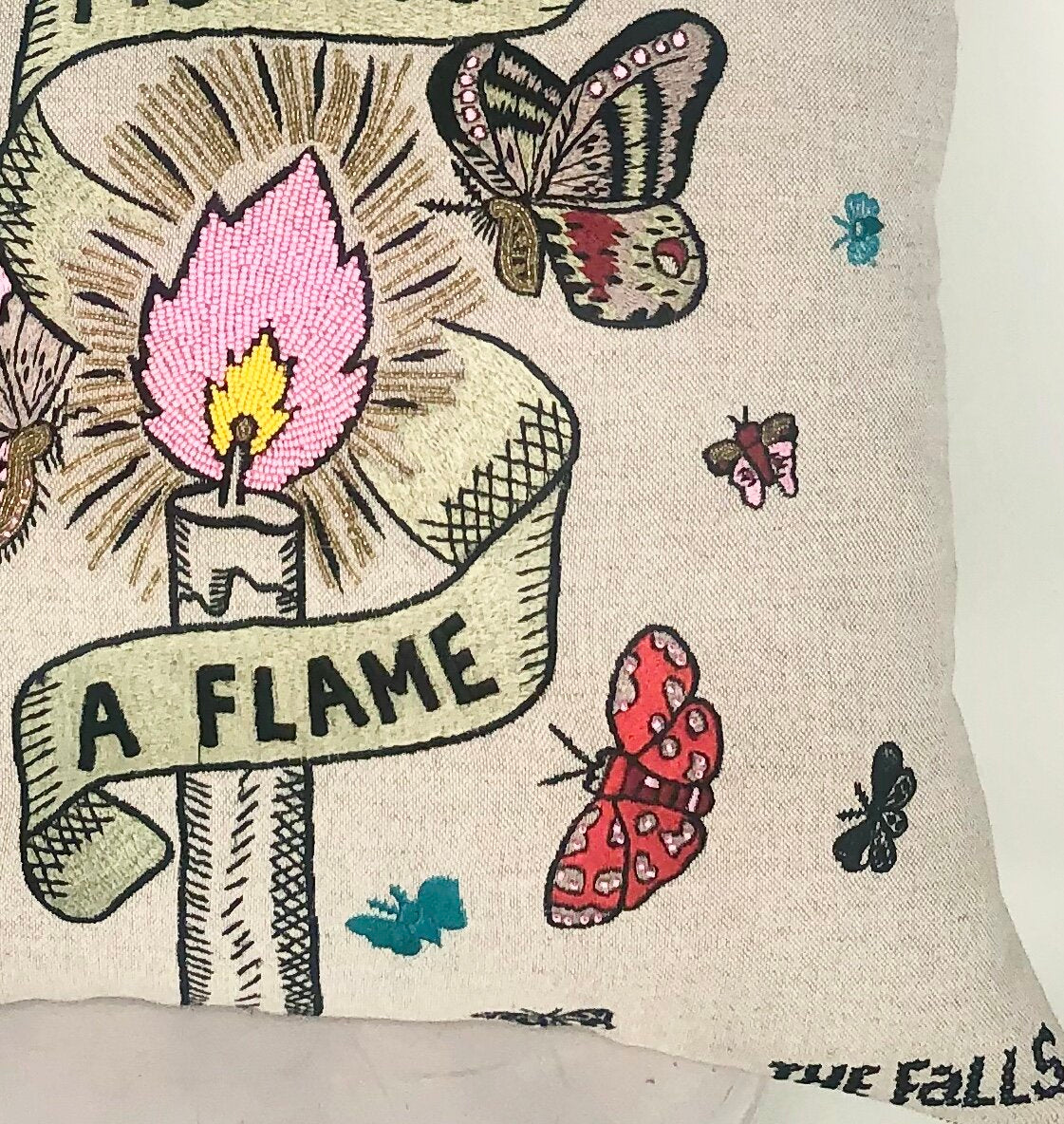 Pillow with embroidery embellishments, close up view 