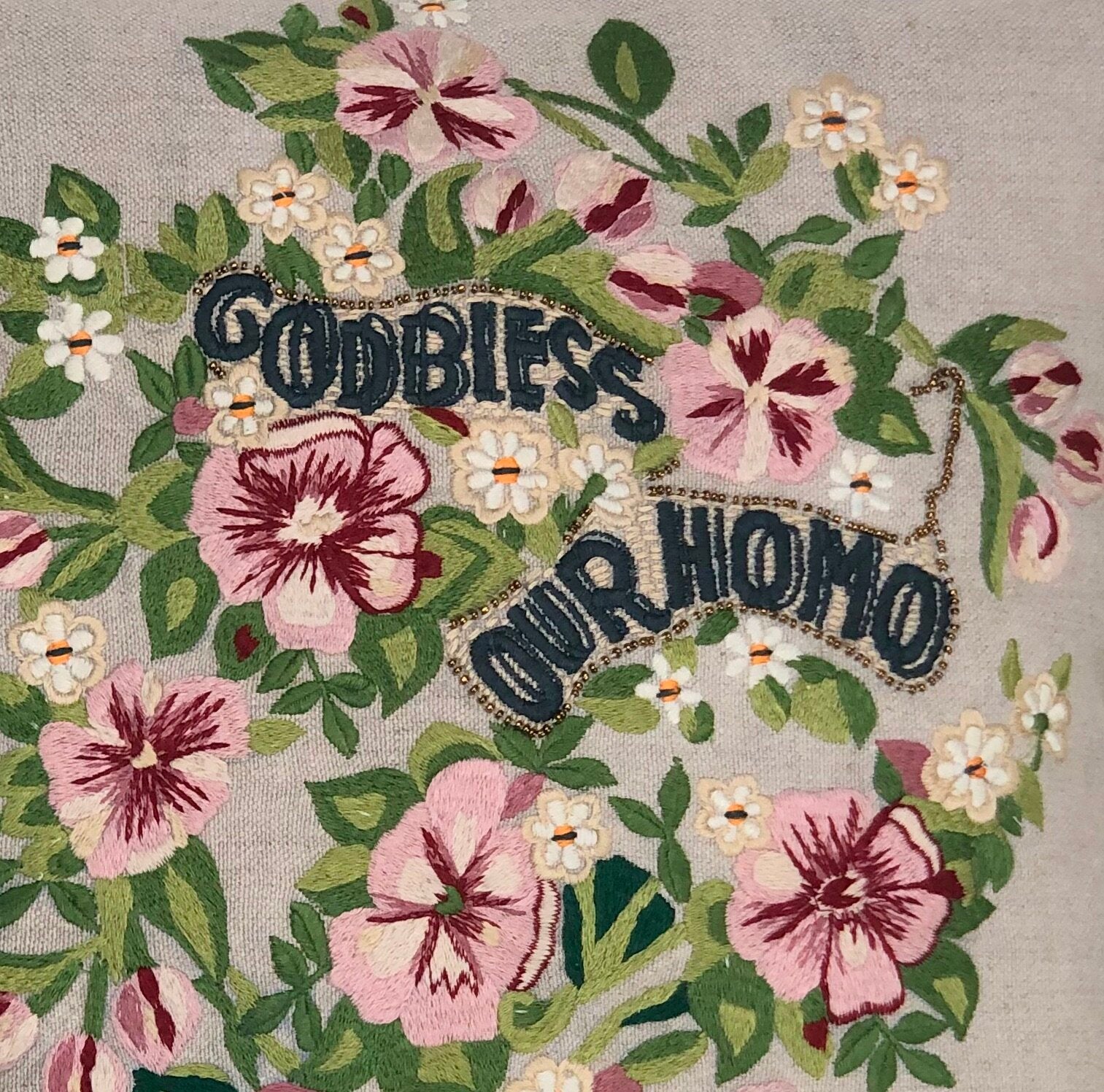 Pillow with embroidery embellishments, close up view 