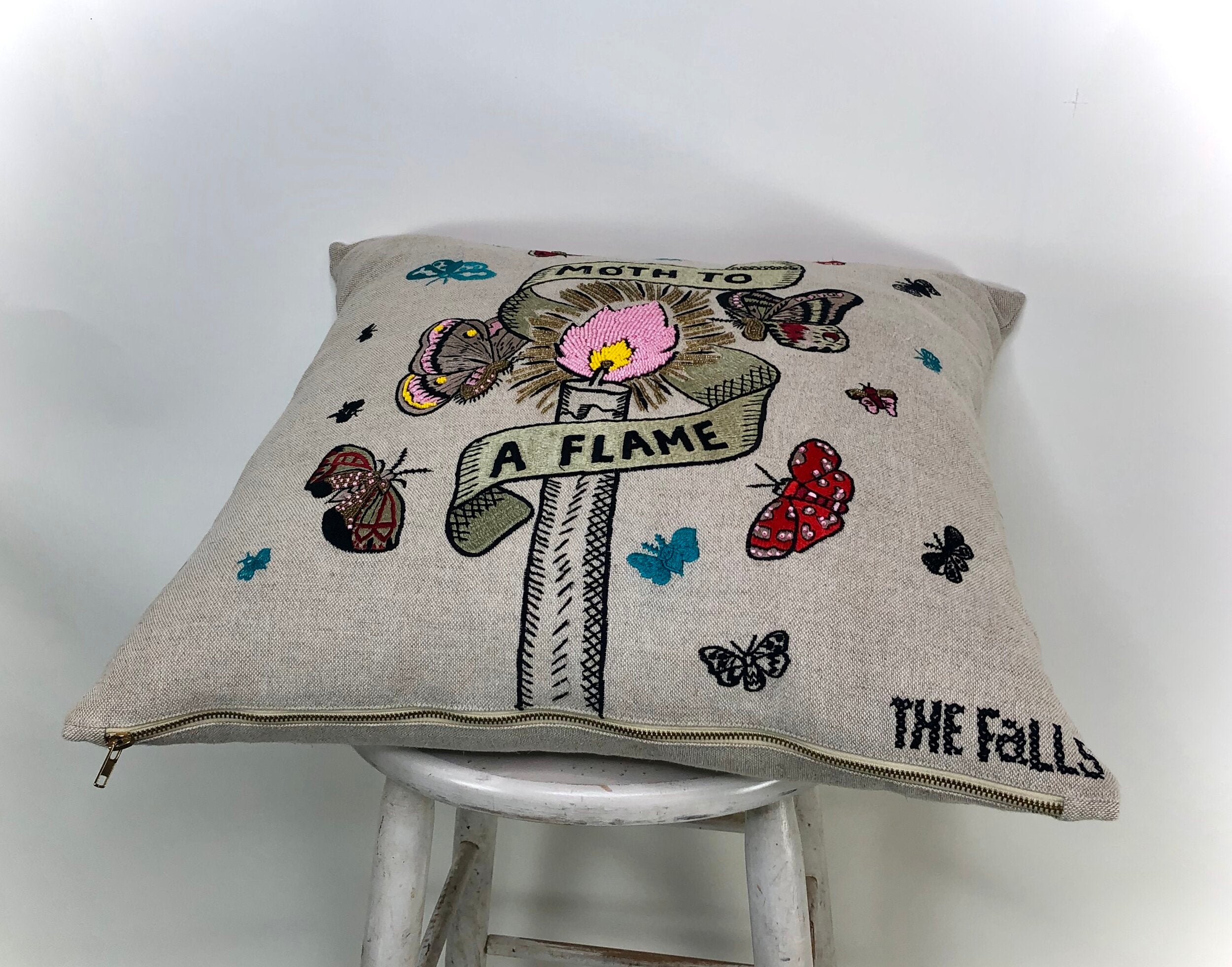 Pillow with embroidery embellishments, side view 