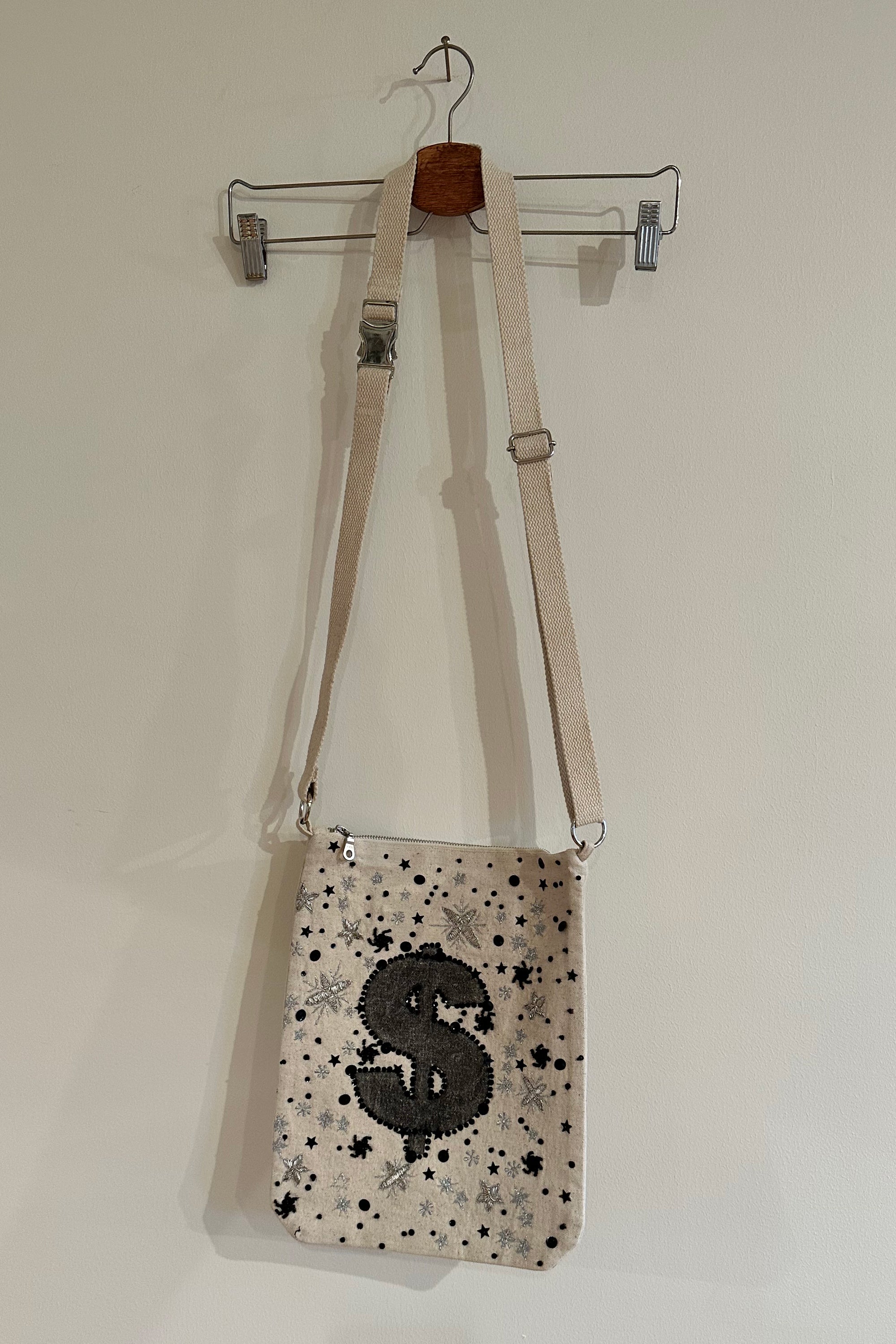 Embellished bag with money sign, front view 