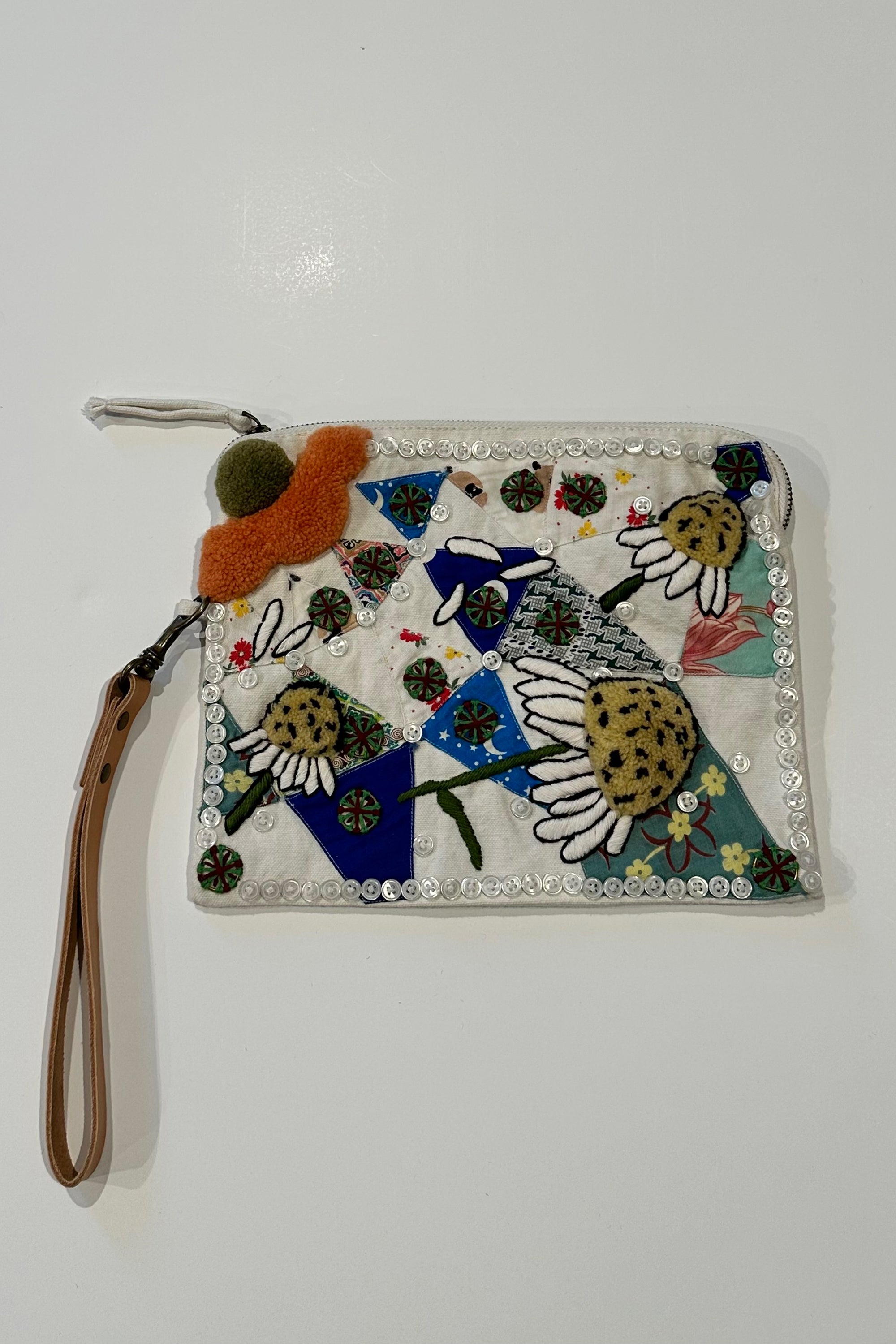 Pouch with embroidered and button embellishments, front view